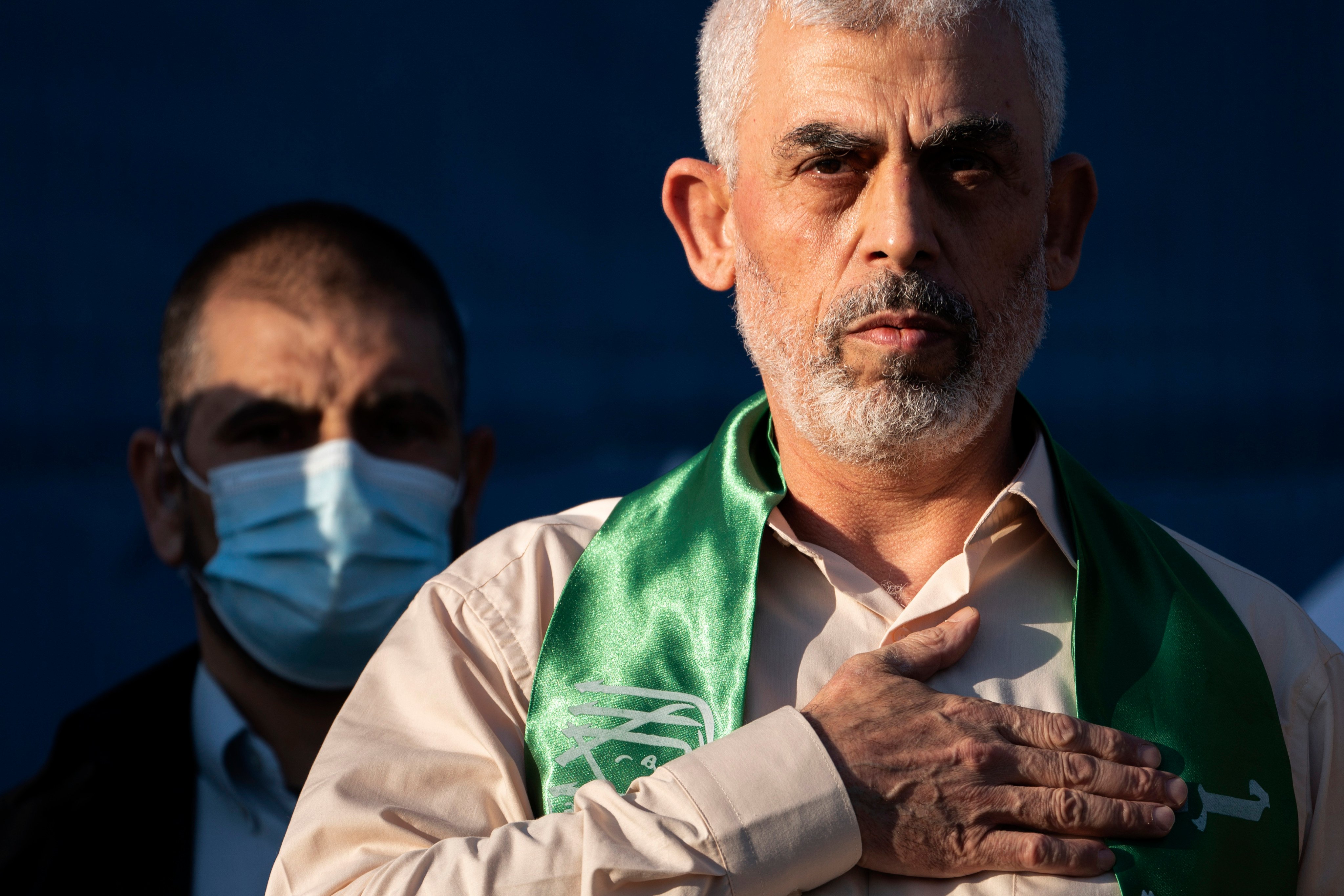 Hamas leader Yahya Sinwar places his hand over his heart on stage after greeting supporters at a rally in Gaza City in May 2021. Photo: AP