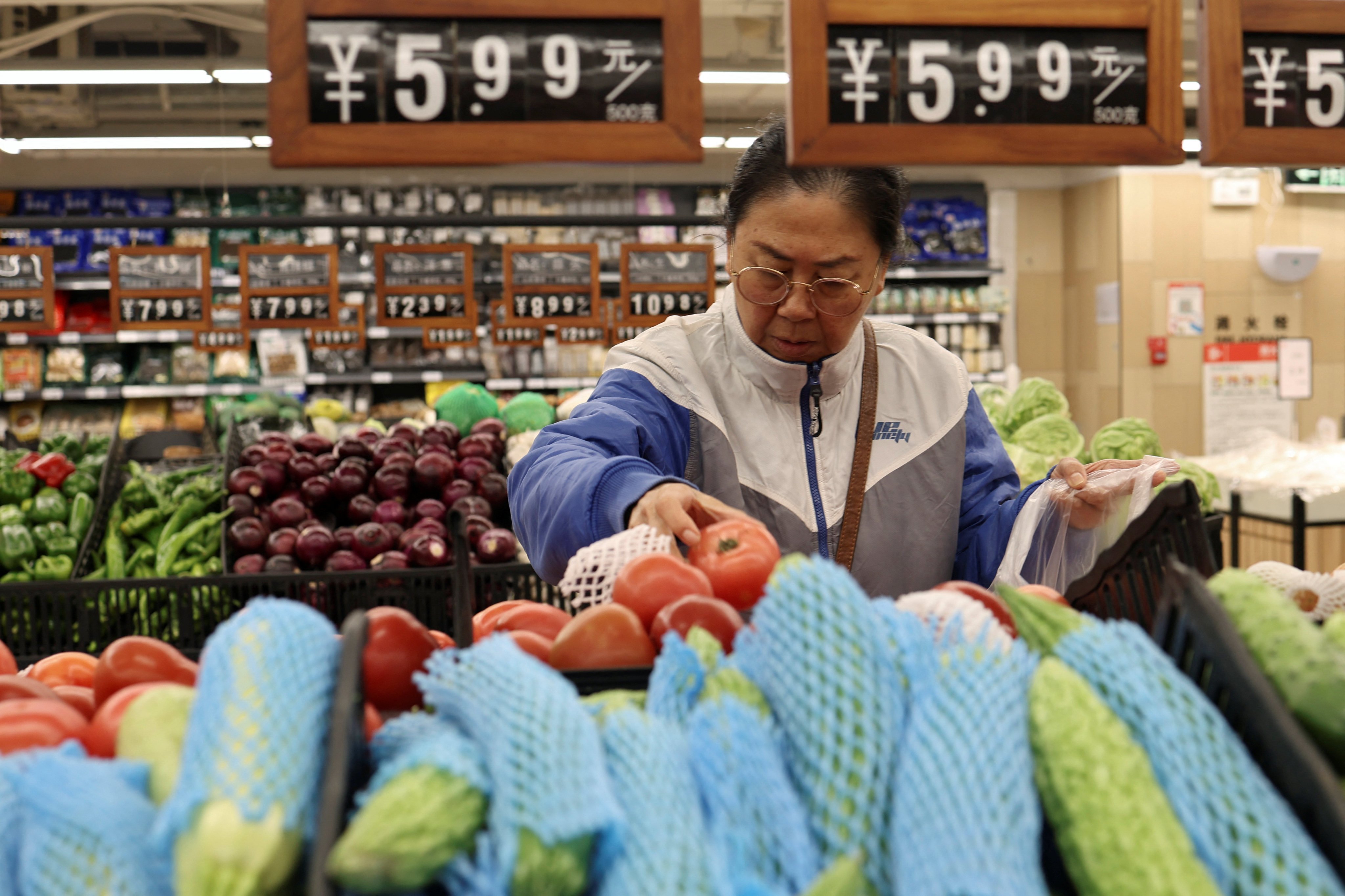 A customer shops at a Beijing supermarket on Thursday. Weak consumption continues to strain China’s economic recovery. Photo: Reuters