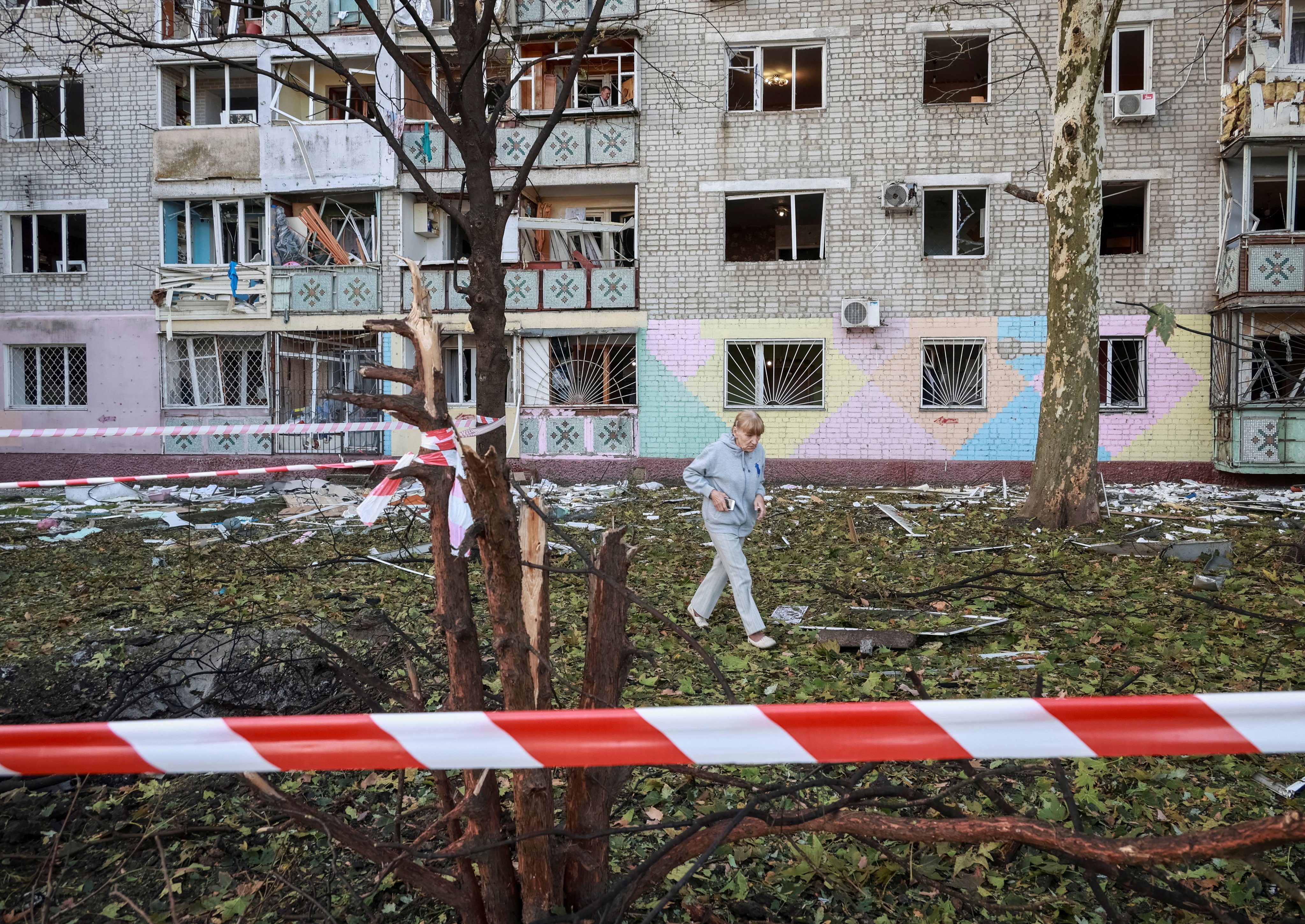 A resident of Chornomorsk, in the Odesa region of Ukraine, walks at the site of a Russian drone strike on October 9. Photo: Reuters