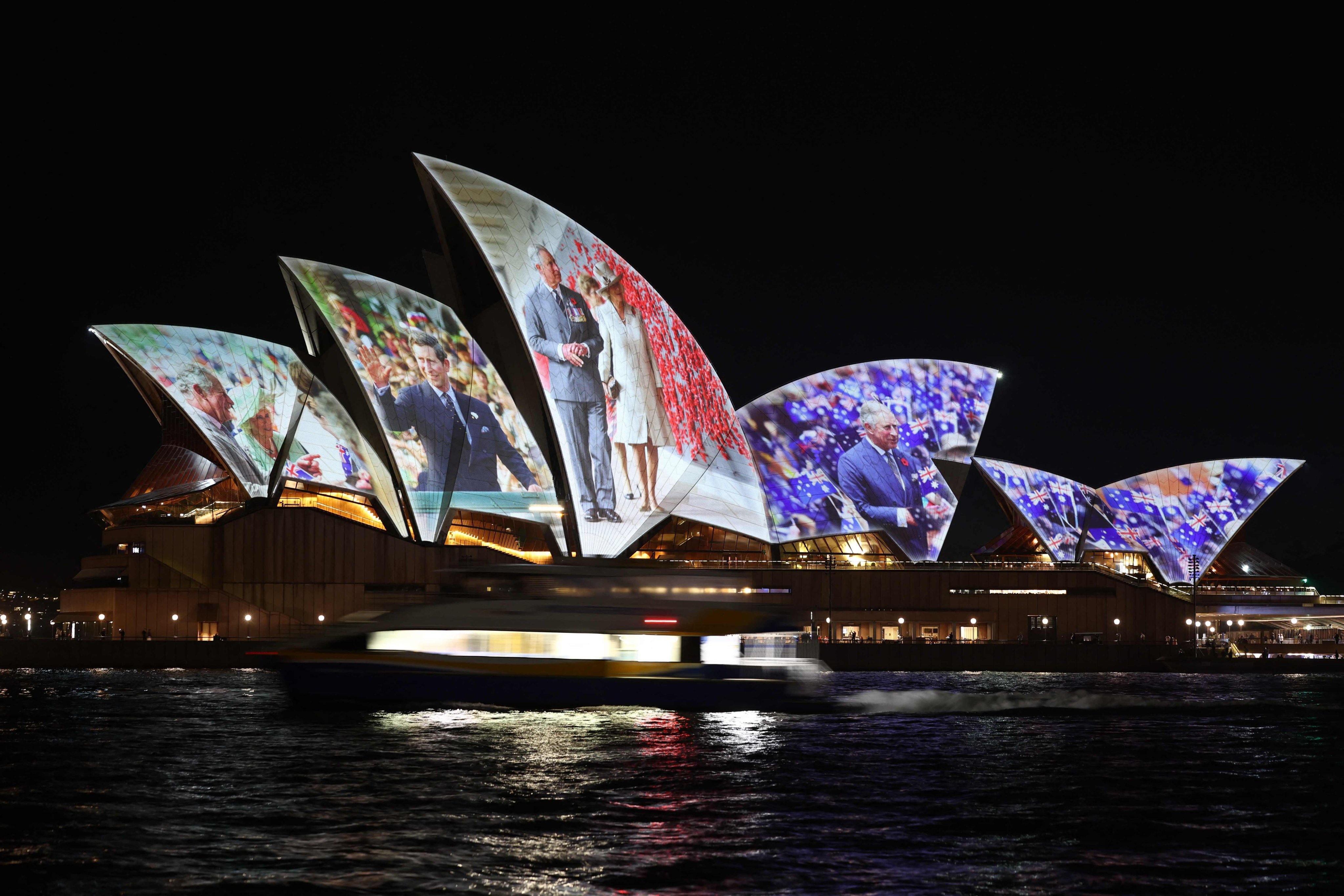 A projection of photographs of Britain’s King Charles III and Queen Camilla is seen on the Sydney Opera House in Sydney on October 18, 2024, as the royals arrive for a six-day visit to Sydney and Canberra. (Photo by David GRAY / AFP)