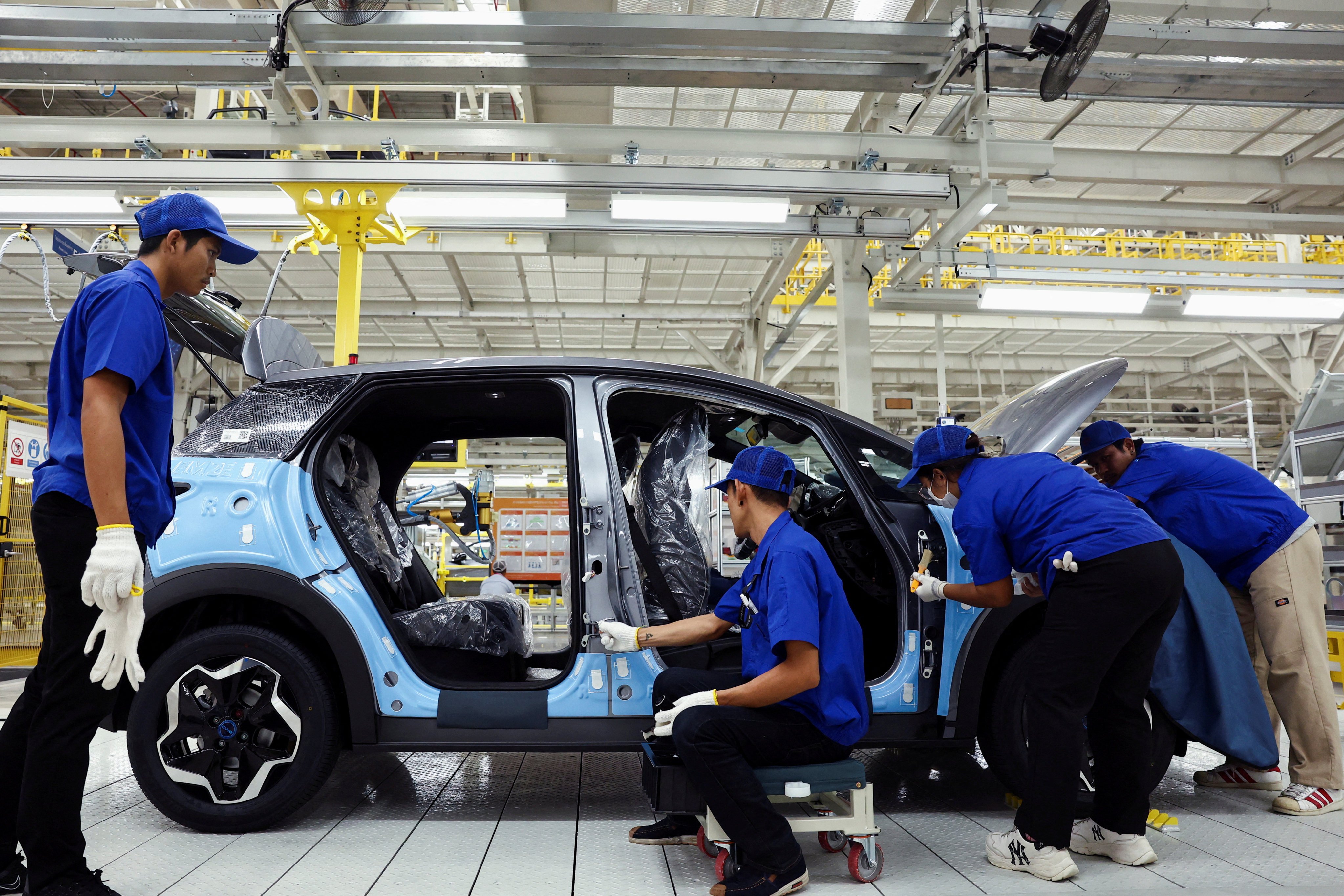 Workers assemble an electric vehicle at Chinese manufacturer BYD’s factory in Rayong, Thailand, which opened in July. Photo: Reuters