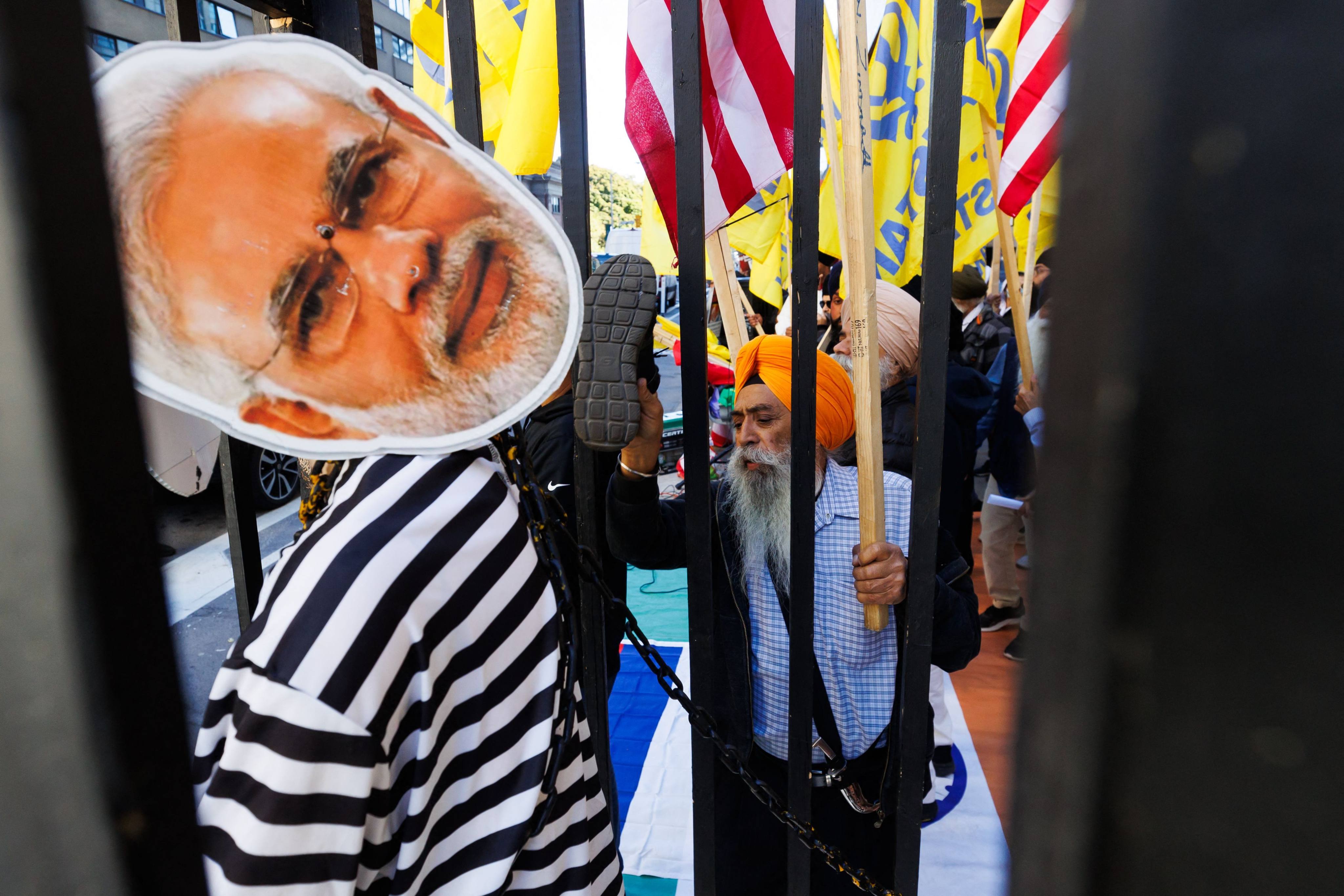 Sikh separatist activists with the Khalistan movement deface a placard and mannequin of Indian Prime Minister Narendra Modi as they protest outside the Consulate General of India in Toronto on Friday. Photo: AFP