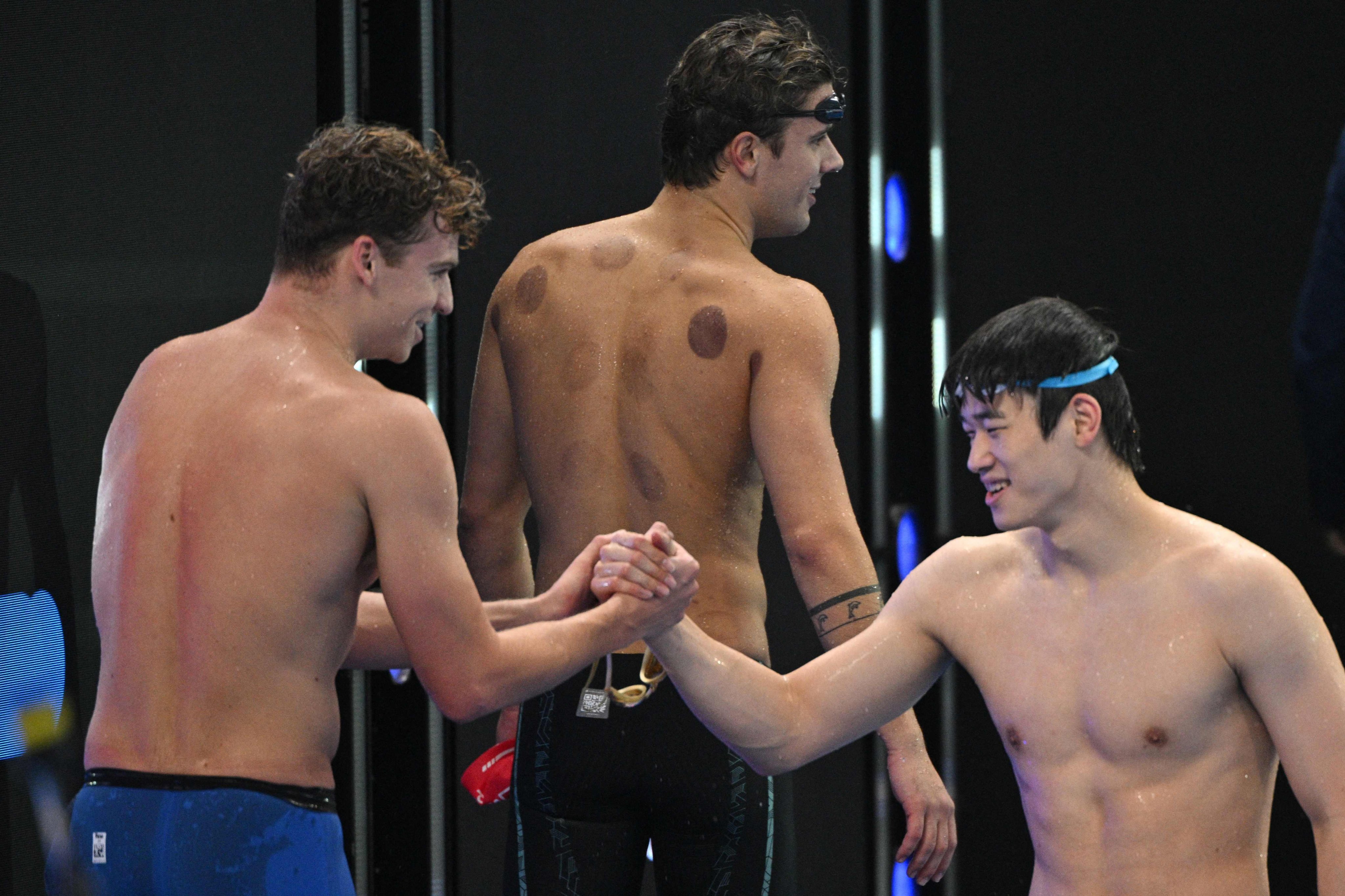 France’s Leon Marchand (left) shakes hands with China’s Pan Zhanle after winning the 100m individual medley at the World Aquatics Swimming World Cup in Shanghai on Friday. Pan finished eighth. Photo: AFP