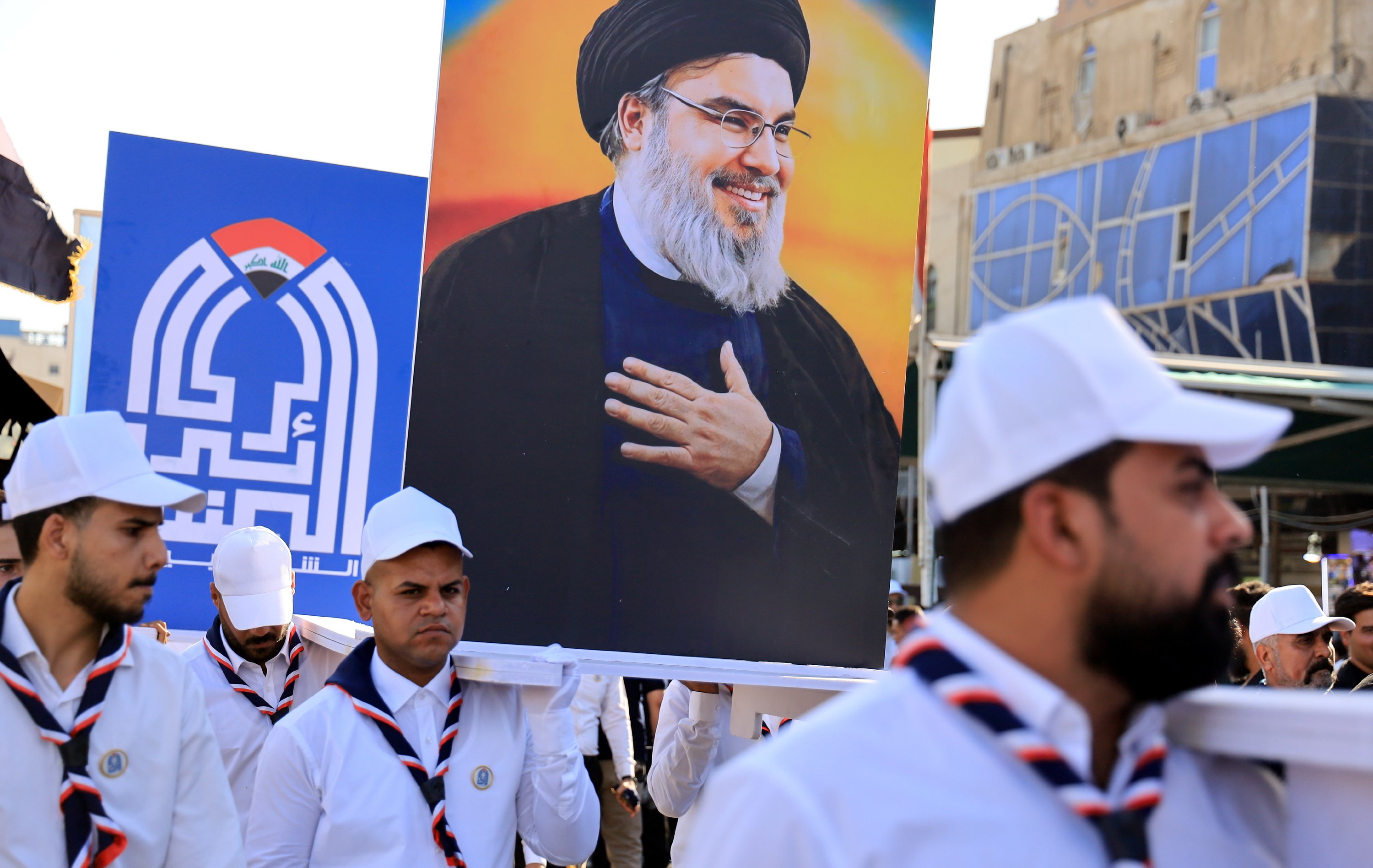 Iraqis carry images of the late Hezbollah leader Hassan Nasrallah during an anti-Israel rally in Karbala, south of Baghdad on Friday. Photo: EPA-EFE