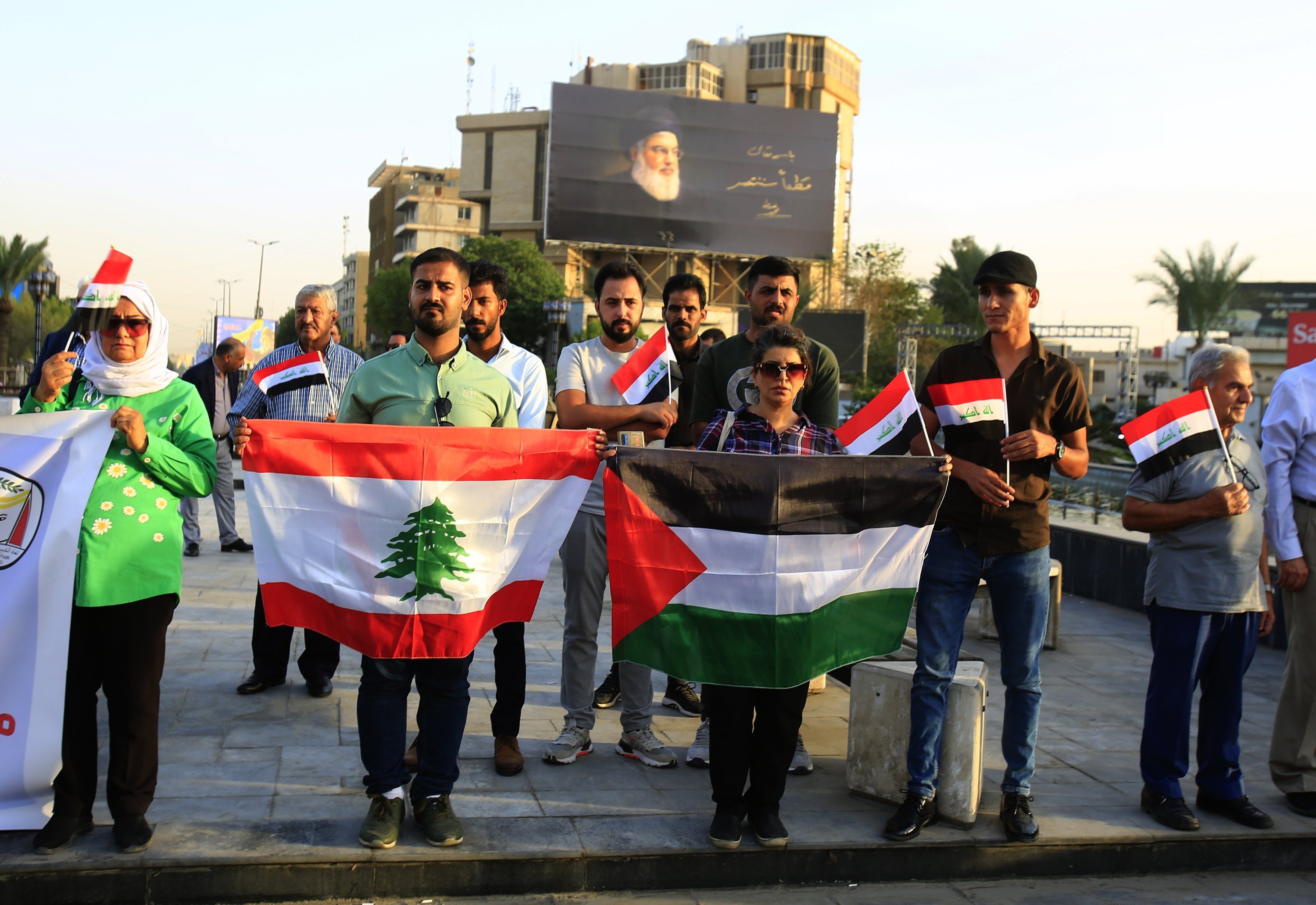 Iraqi activists hold the Palestine and Lebanon flag during a gathering at Al-firdos square in central Baghdad, Iraq, on Friday. Dozens of activists gather in central Baghdad to denounce the ongoing Israeli military strikes and operations in both Lebanon and the Gaza Strip. Photo; EPA/EFE