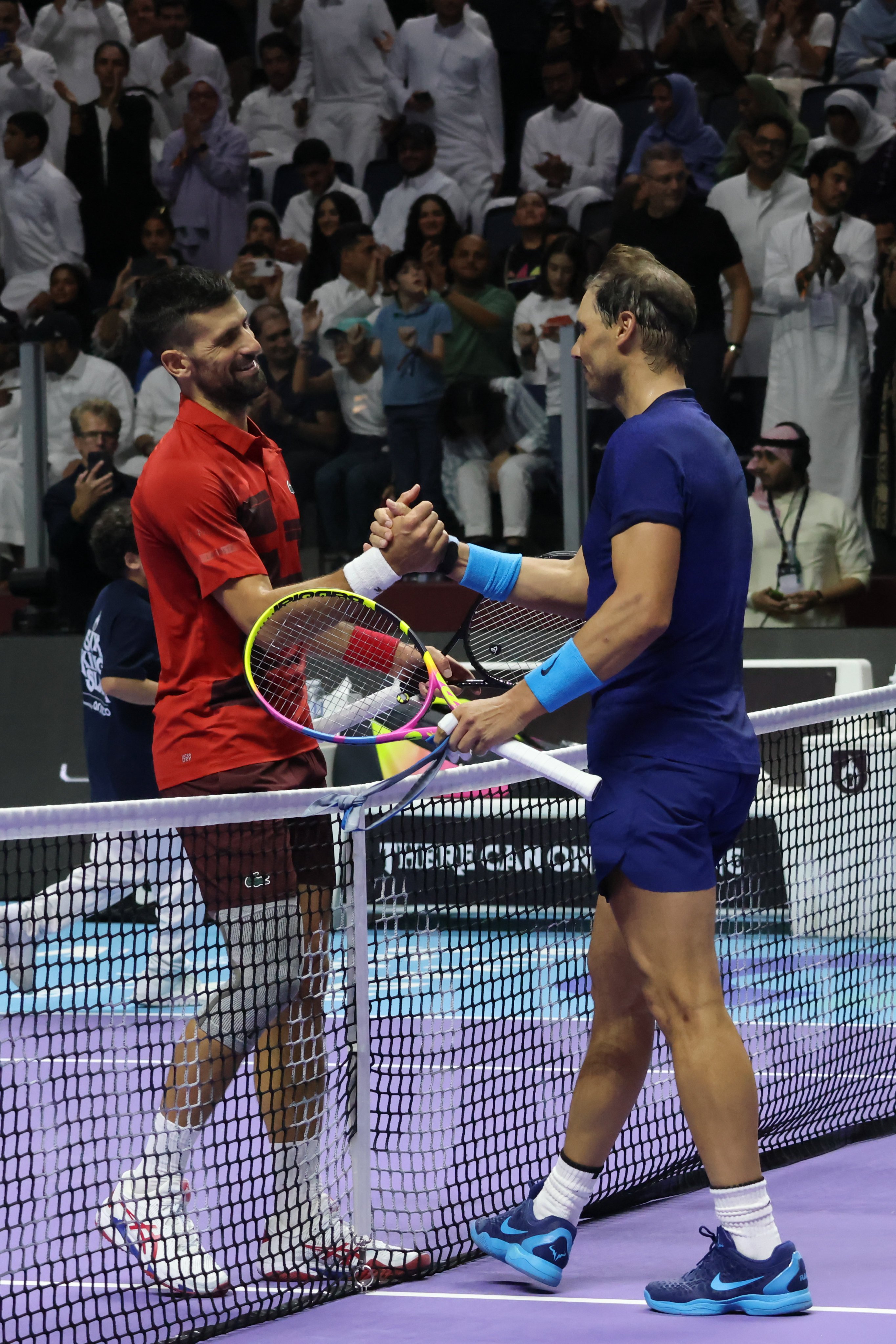 Novak Djokovic and Rafa Nadal meet at the net at the end of what was likely their final ever meeting. Photo: Xinhua