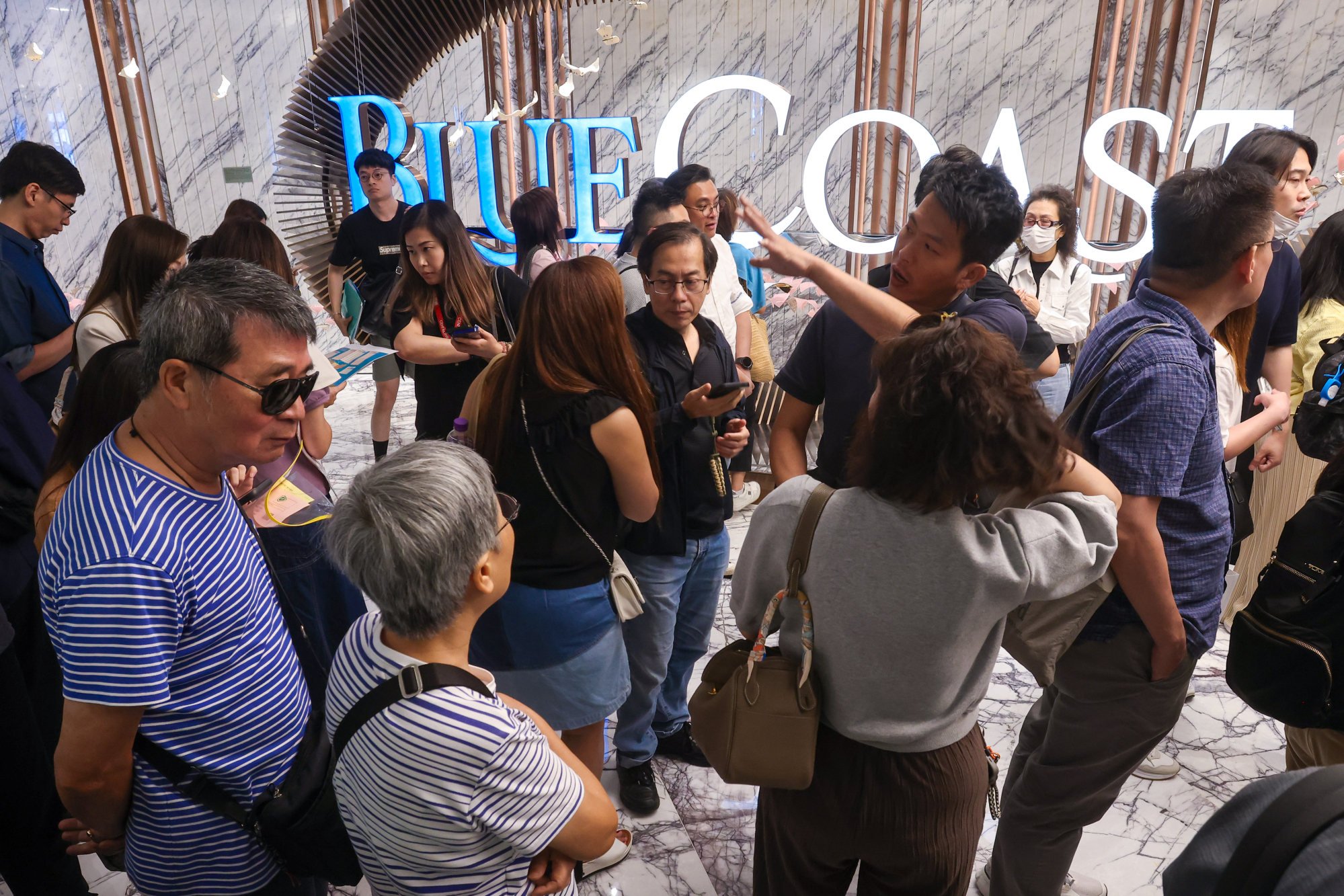 Prospective buyers swamp Blue Coast ll sales office at Fortune Metropolis in Hung Hom on October 19 2024. Photo: Jonathan Wong