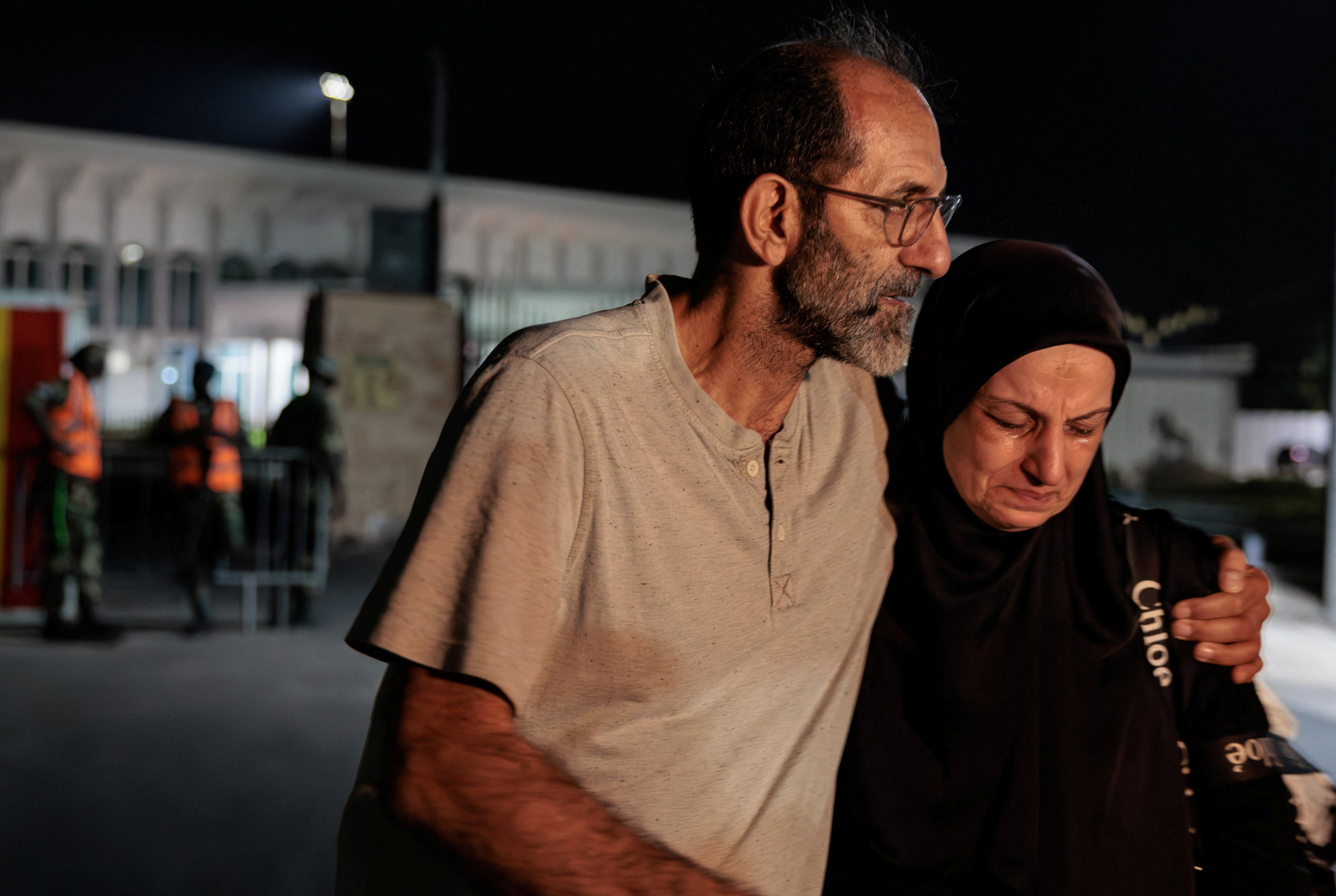 Hussein Hachem hugs his wife Hala after she arrives on a repatriation flight in Dakar, Senegal, on Saturday. Their son, 14, was killed in an Israeli strike on Lebanon. Photo: Reuters