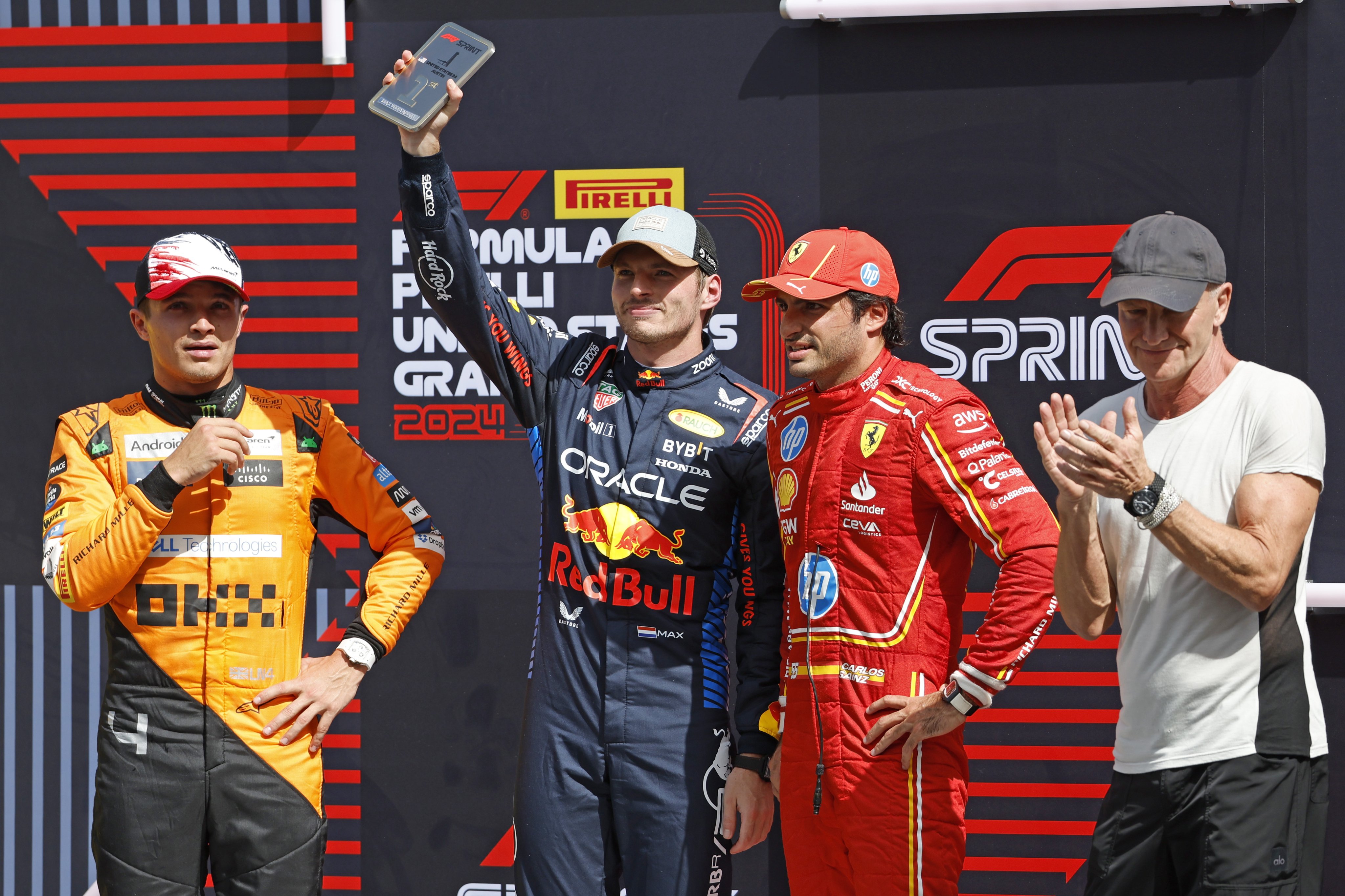 Max Verstappen (centre) celebrates his first victory for four months after winning the US GP with Carlos Sainz ( second right) second and Lando Norris (left) third. Photo: EPA