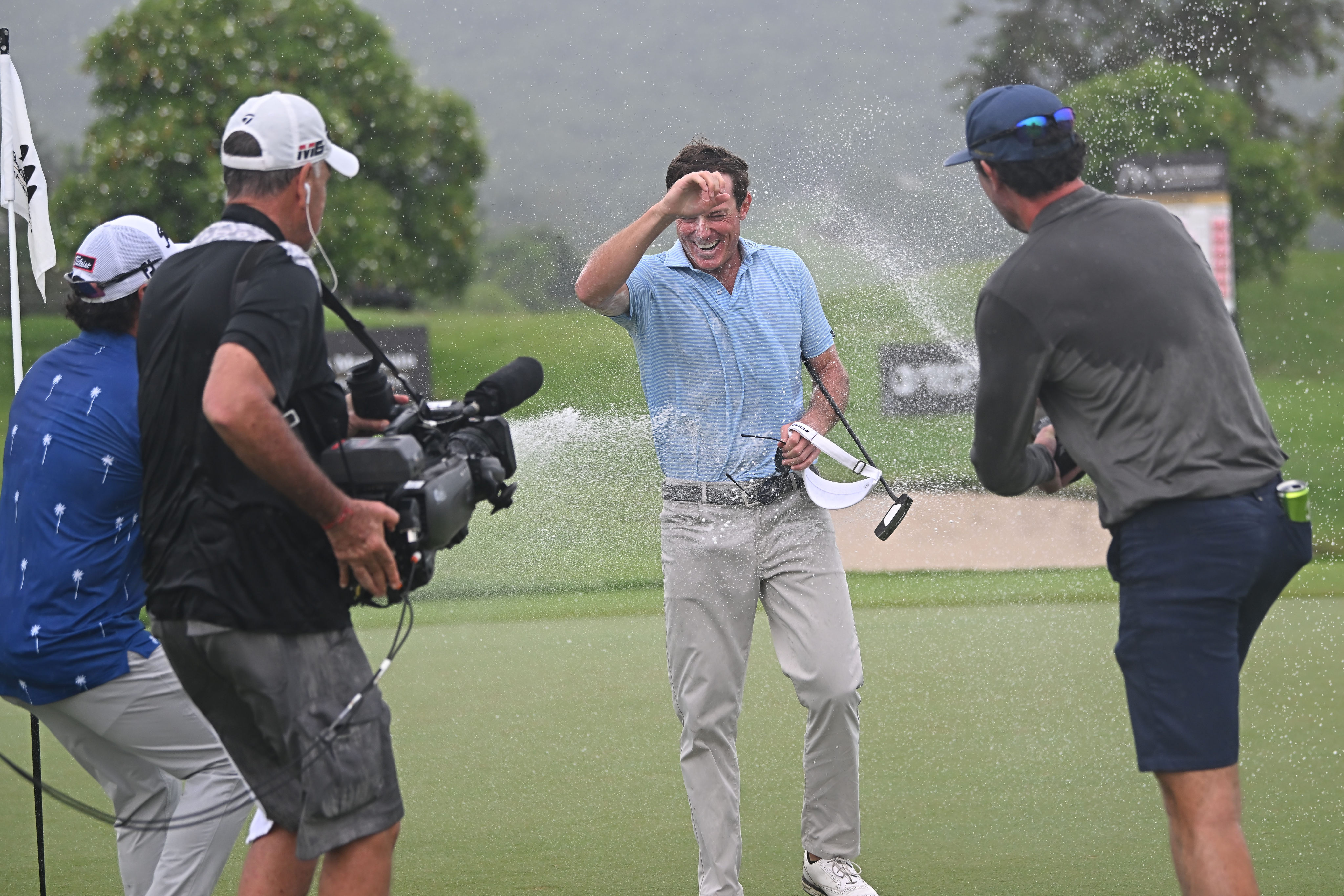 Michael Maguire gets sprayed with champagne after winning the Black Mountain Championship, an International Series event on the Asian Tour. Photo: Asian Tour