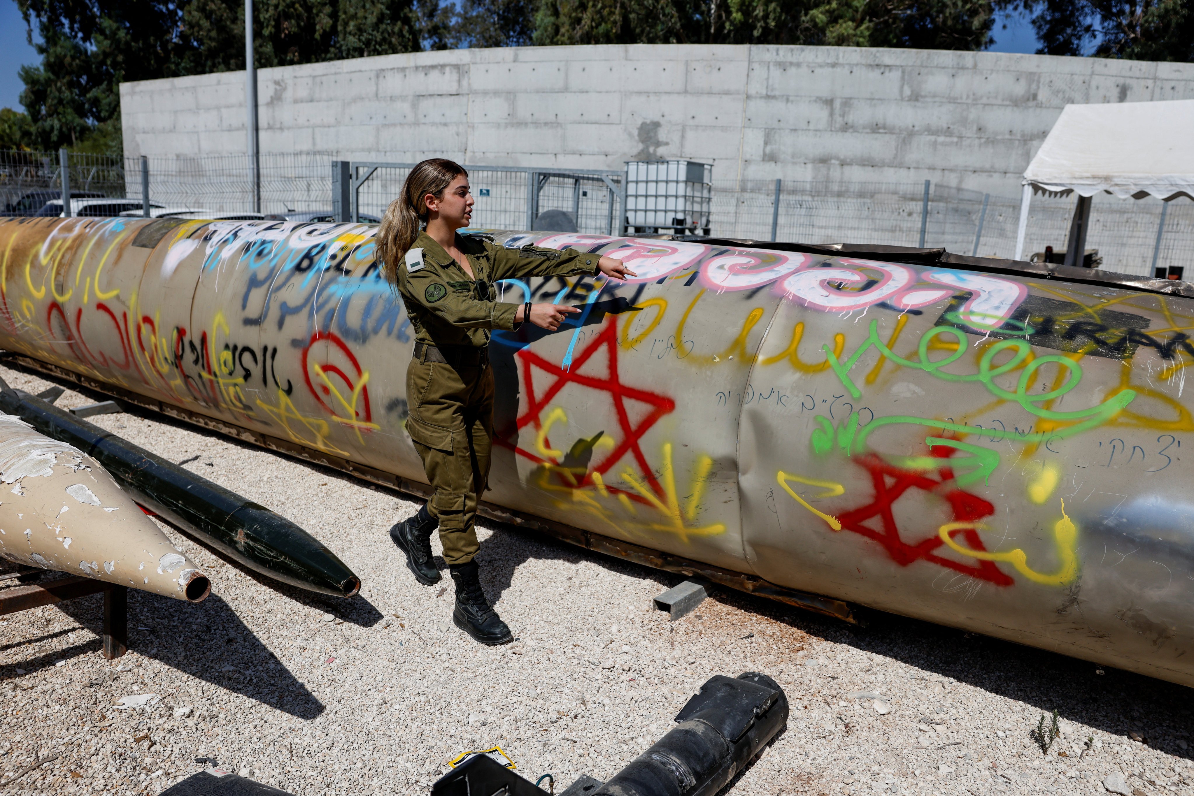 An Israeli soldier stands next to the remains of a Emad ballistic missilesat Julis army base on October 9, days after an attack by Iran on Israel. Photo: Reuters