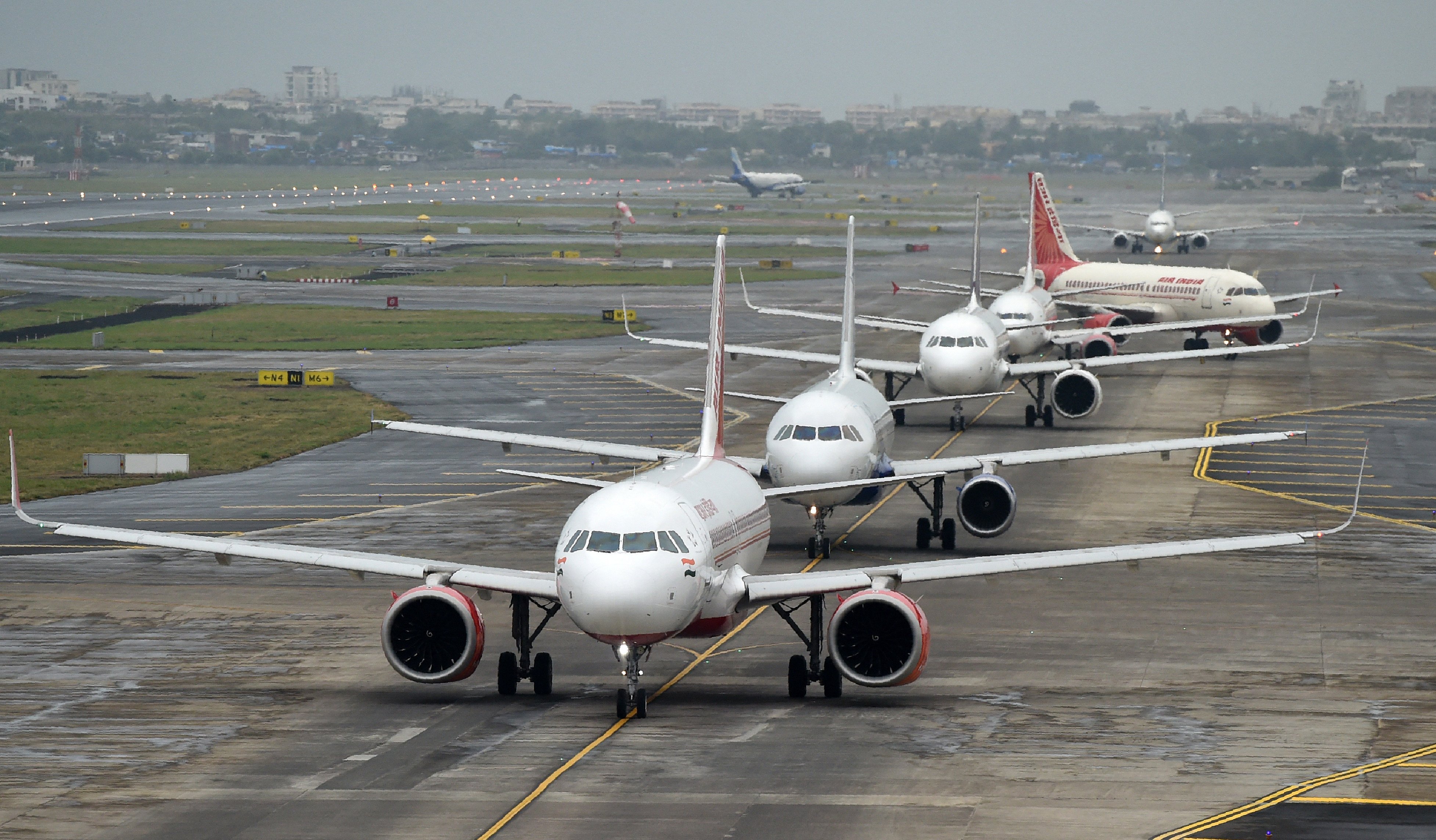 Planes queue up on the tarmac before taking off at an airport in Mumbai, India. Photo: AFP