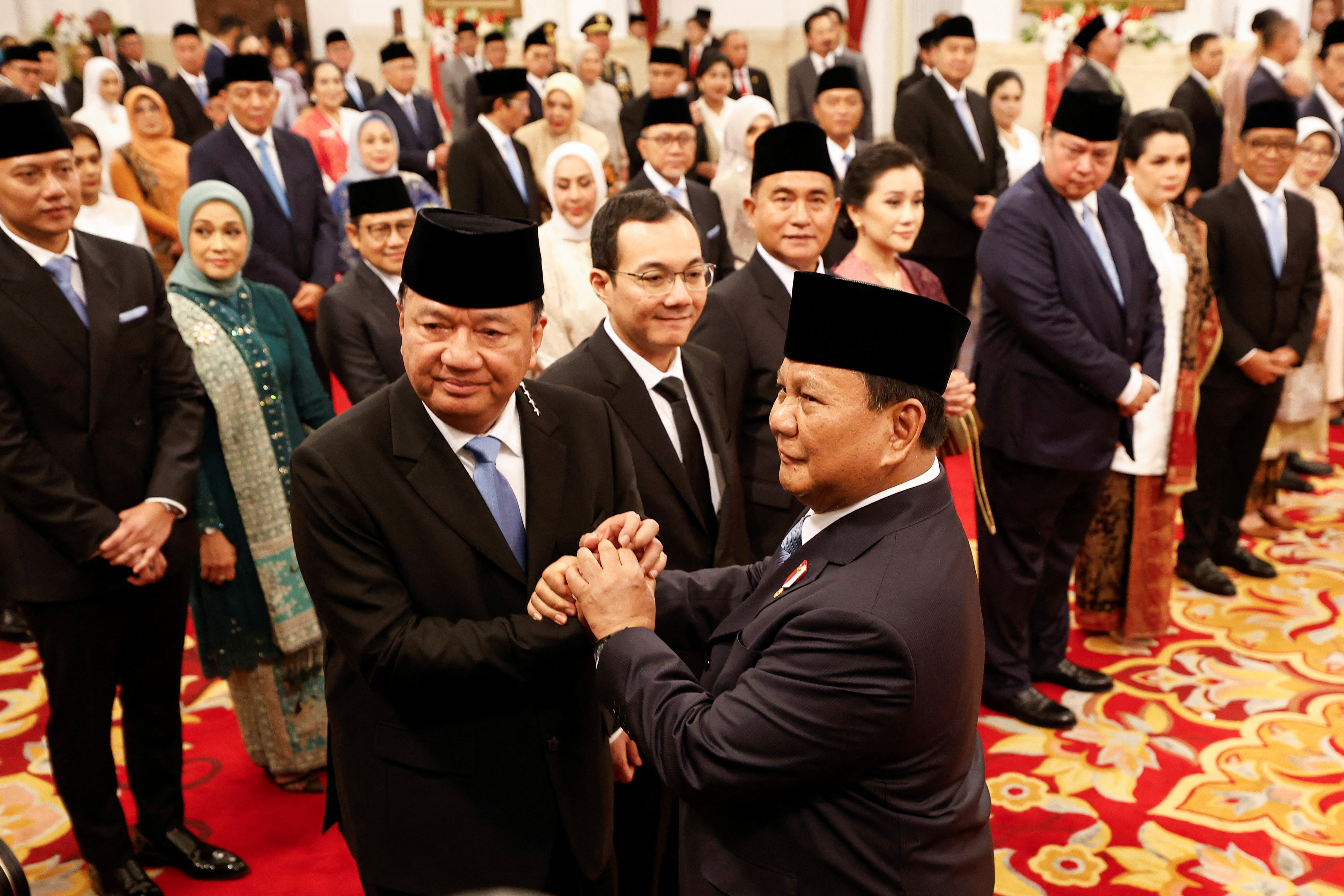 Indonesian President Prabowo Subianto congratulates Coordinating Minister for Political and Security Affairs Budi Gunawan during an inauguration in Jakarta on Monday. Photo: Reuters