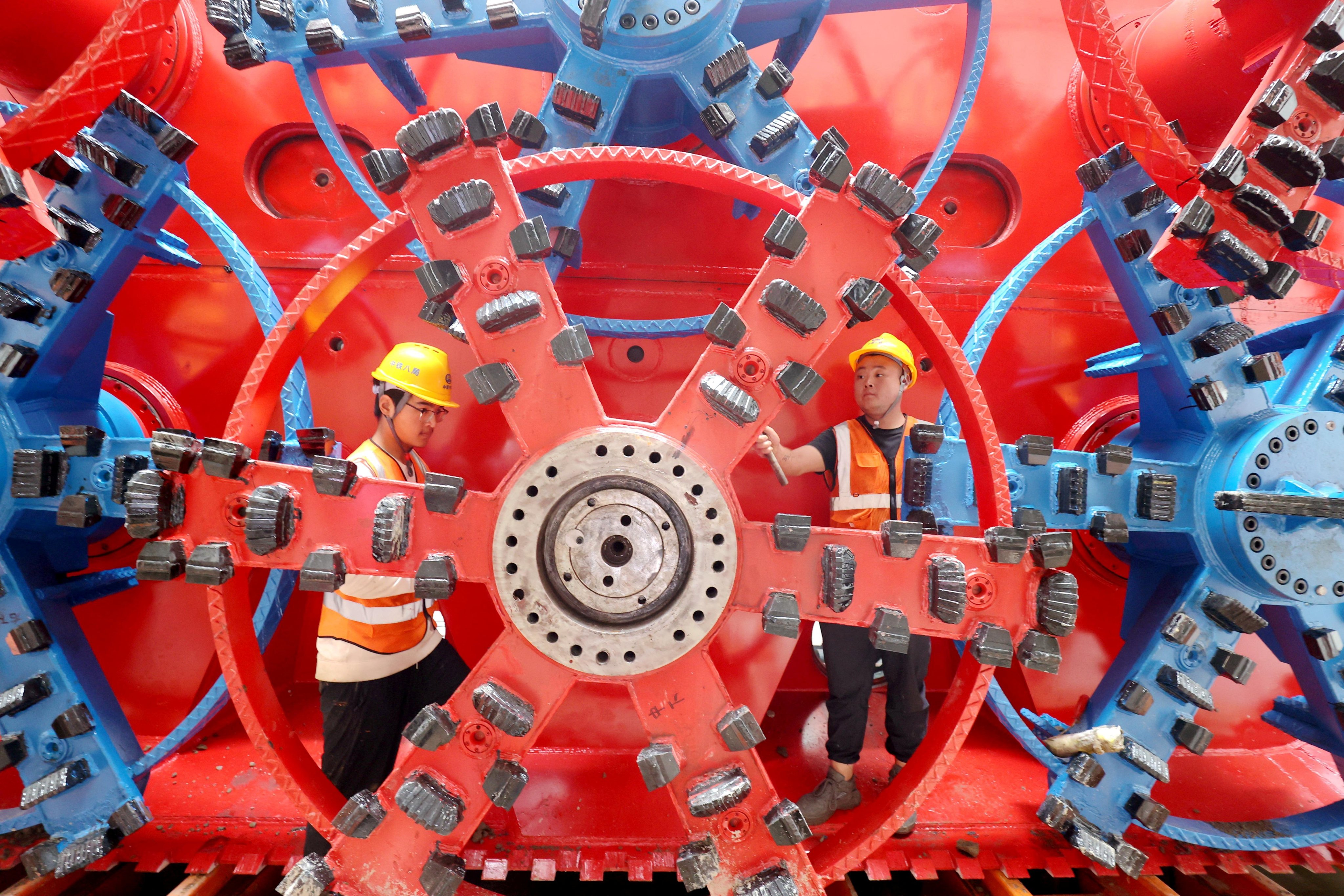 China Railway workers assemble a pipe jacking machine at the construction site of an underground railway station, in Huzhou, Zhejiang province. Photo: Reuters