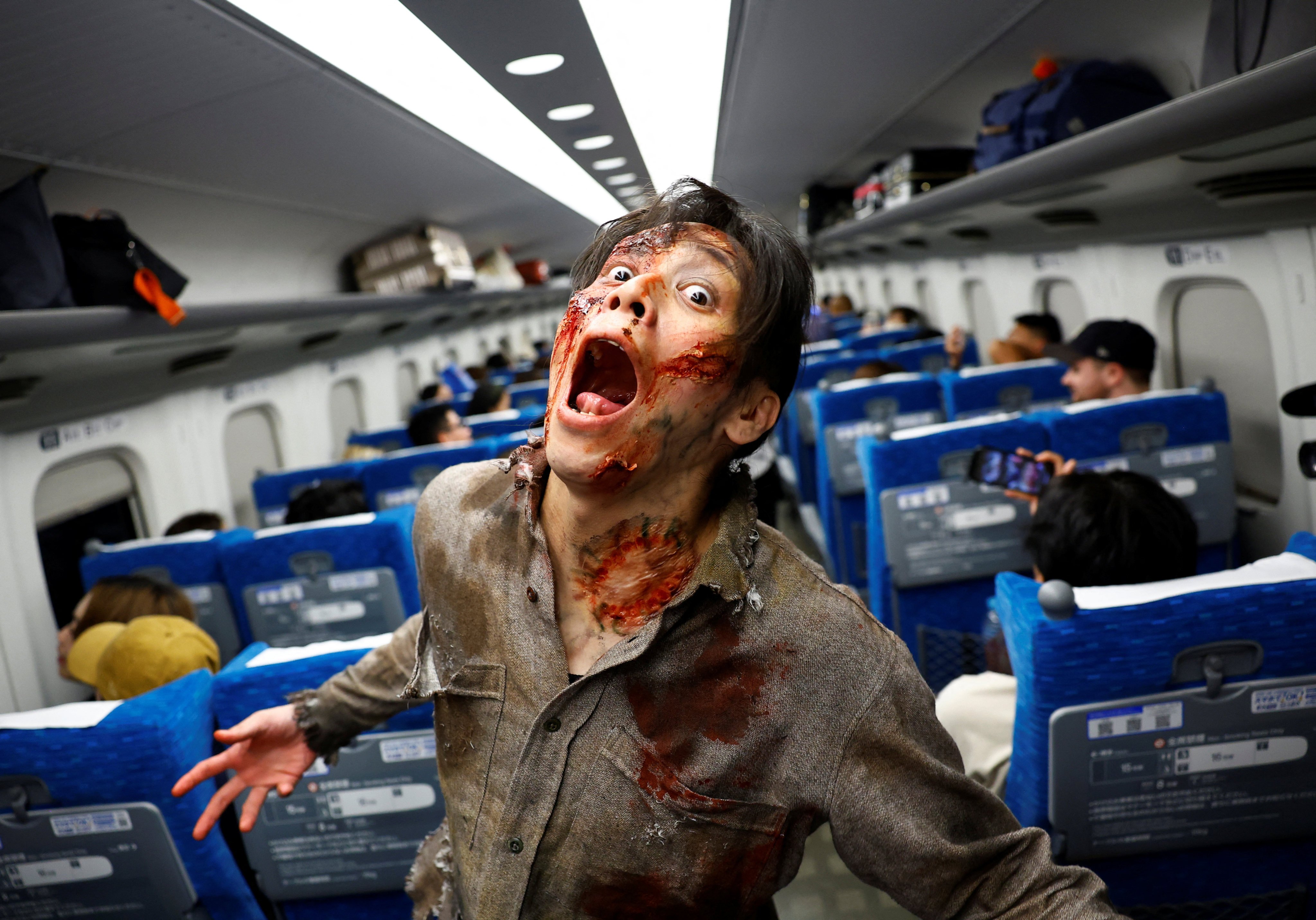 A performer dressed as a zombie for an encounter in a carriage of a Japanese high-speed train. The experience, for which guests paid up to US$335, took place on a Tokyo to Osaka service and was inspired by the hit Korean movie Train to Busan. Photo: Reuters