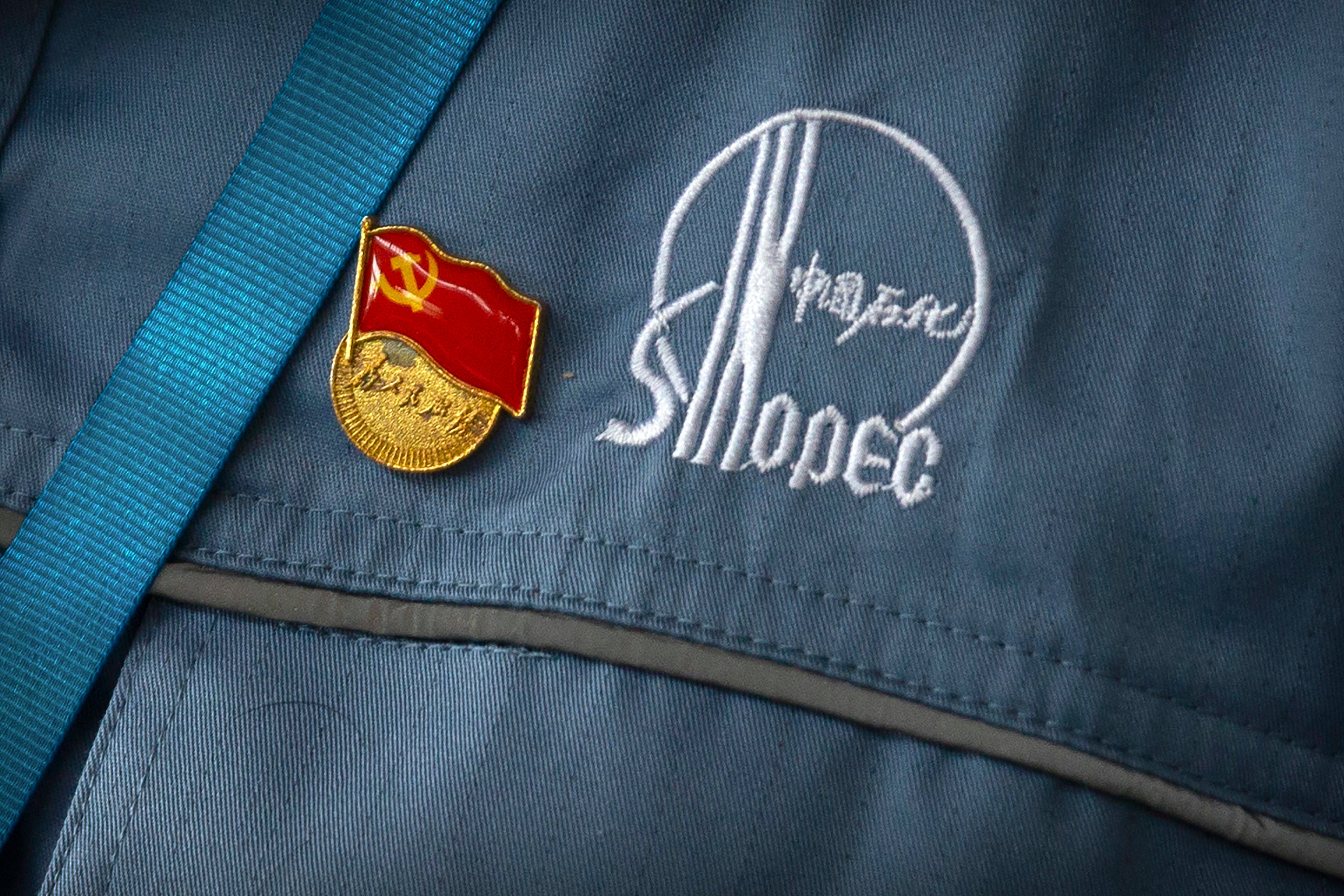 A Chinese Communist Party badge is seen pinned to a worker’s uniform at a Sinopec facility near Beijing in 2018. Photo: AP