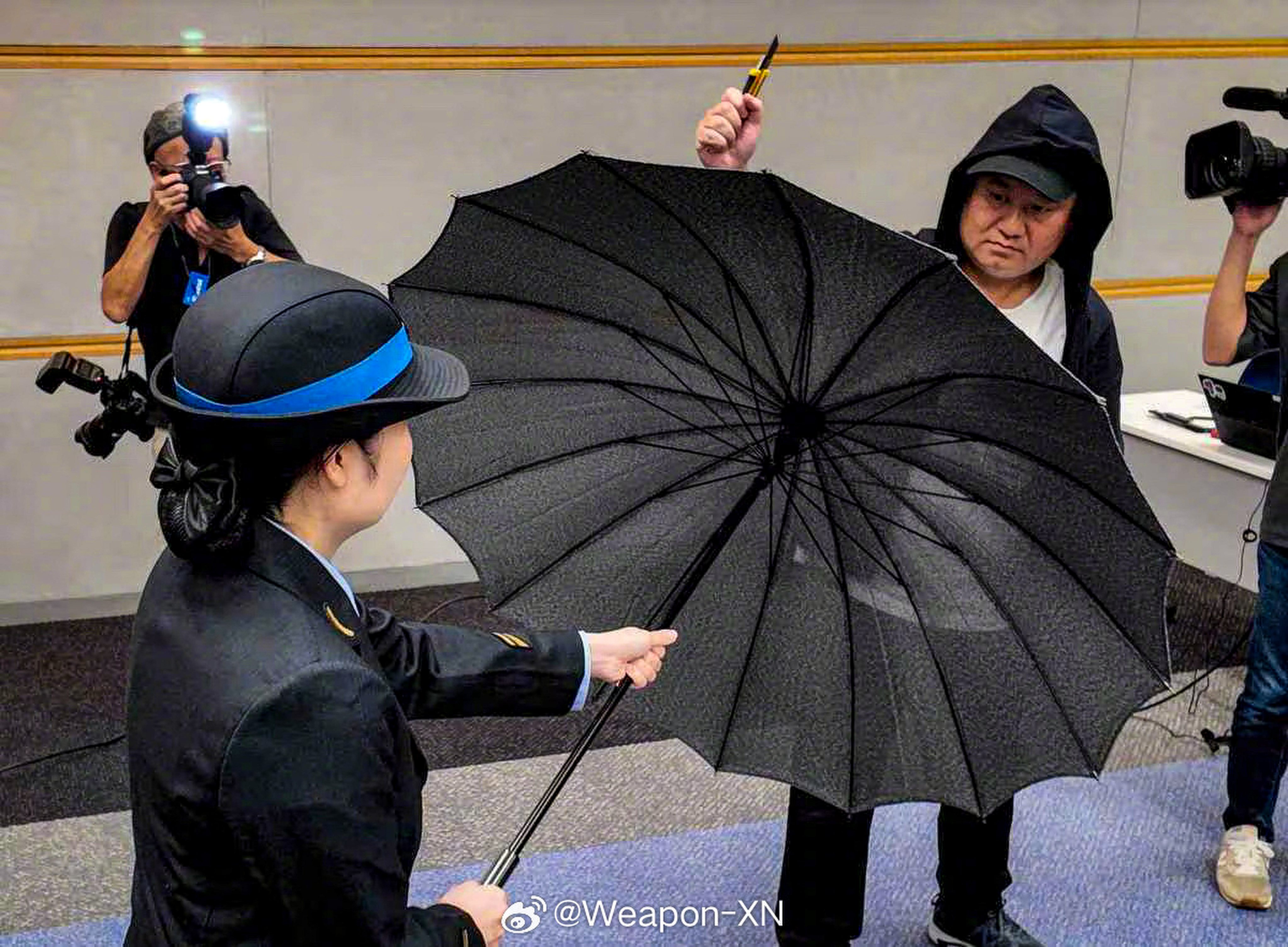 West Japan Railway Co (JR West) demonstrating the new blade-proof umbrellas during a press conference at its headquarters in Osaka on Thursday. Photo: Weibo / Weapon-XN