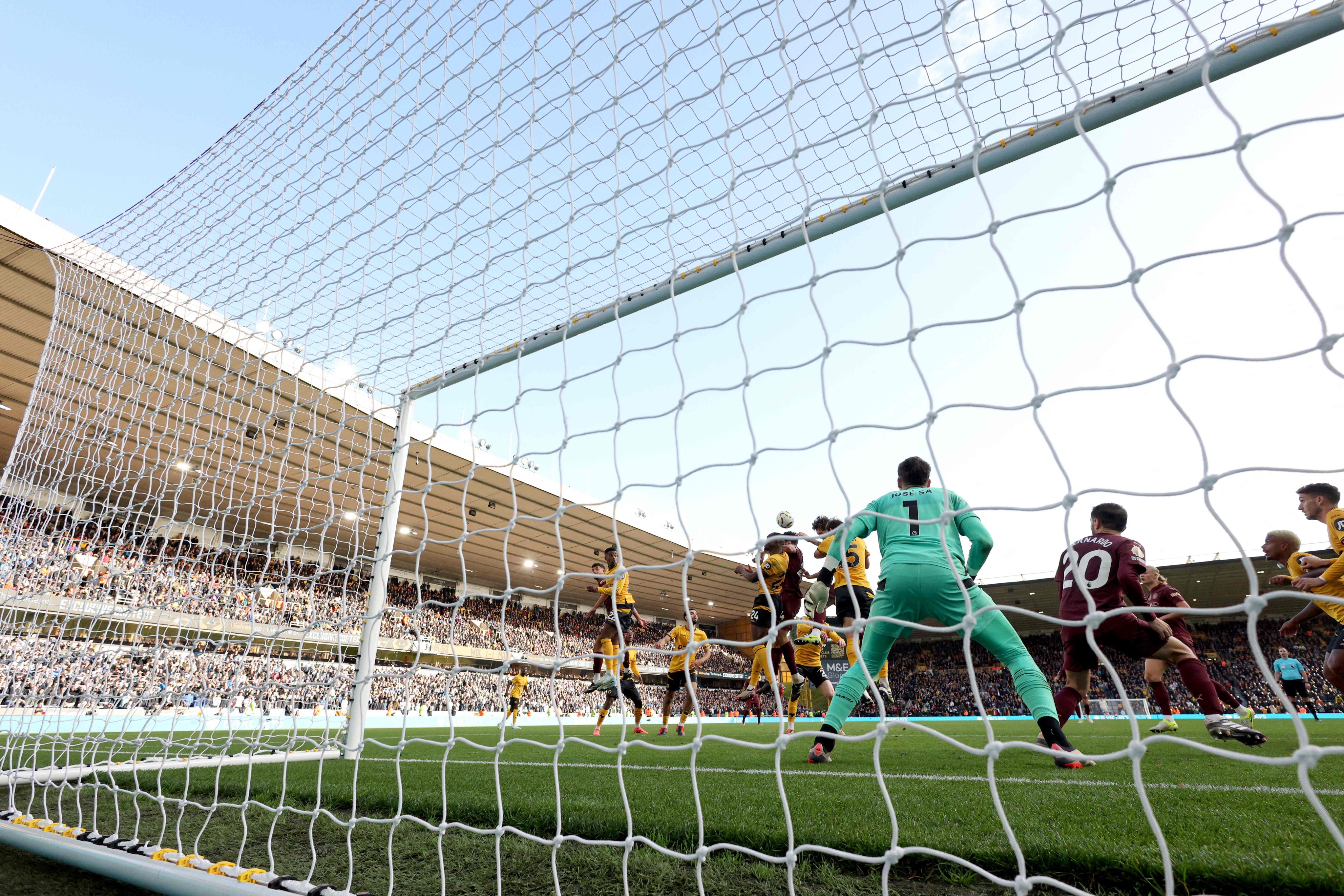 Manchester City’s John Stones scores his team’s controversial winner against Wolves at Molineux. Photo: AFP