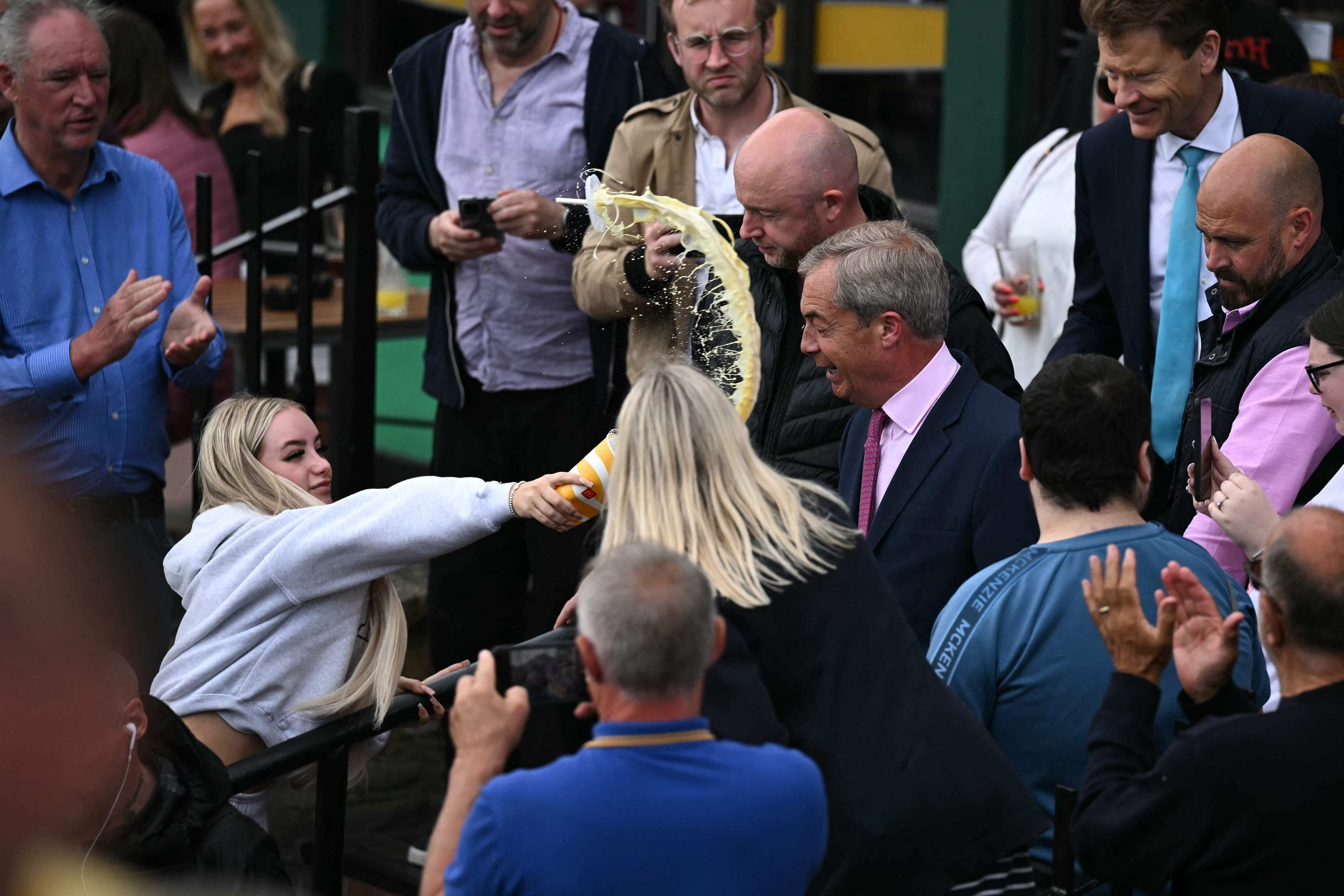 Victoria Thomas Bowen throws a milkshake in Nigel Farage’s face on June 4. Photo: AFP