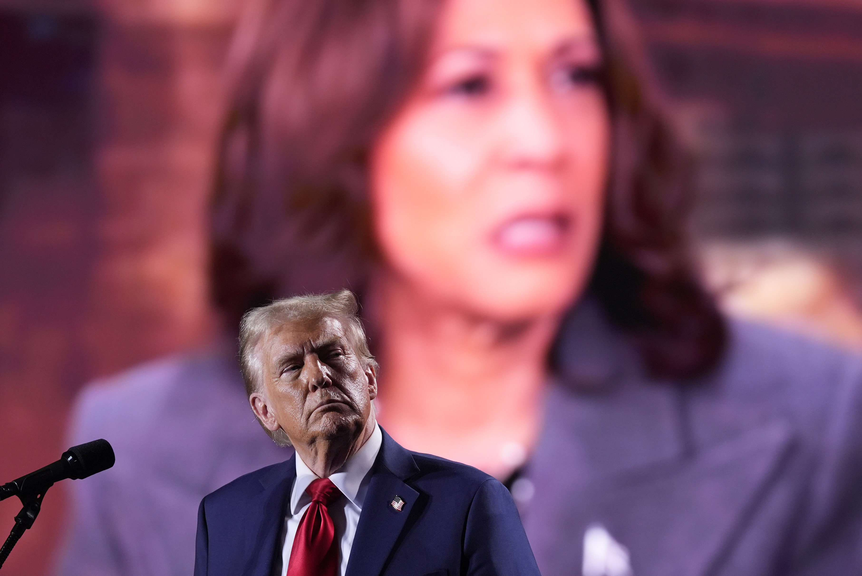 Donald Trump watches as a video featuring Democratic presidential nominee Vice-President Kamala Harris. Photo: AP