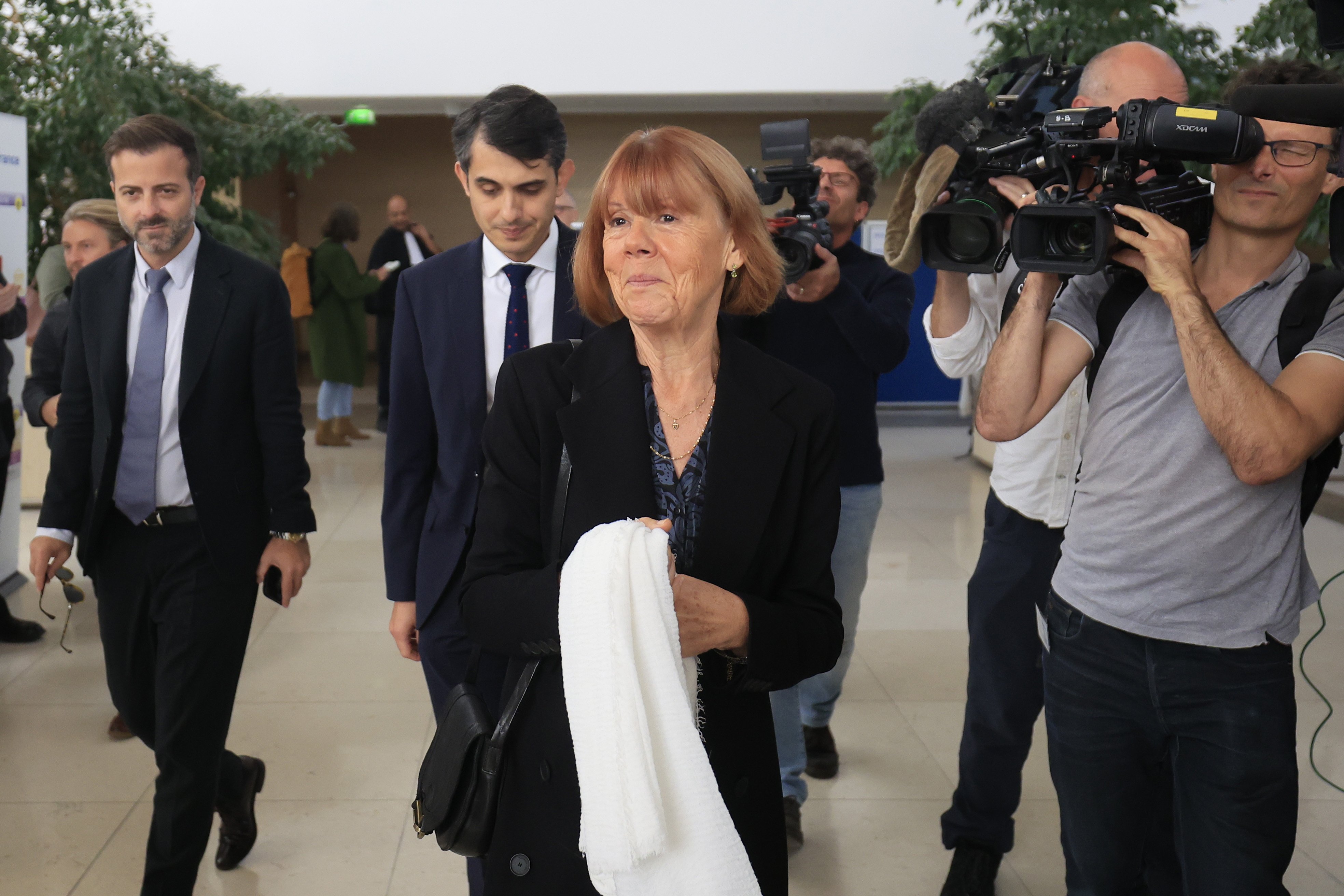 Gisele Pelicot (middle), escorted by her lawyers, leaves the criminal court in Avignon. Photo: EPA-EFE