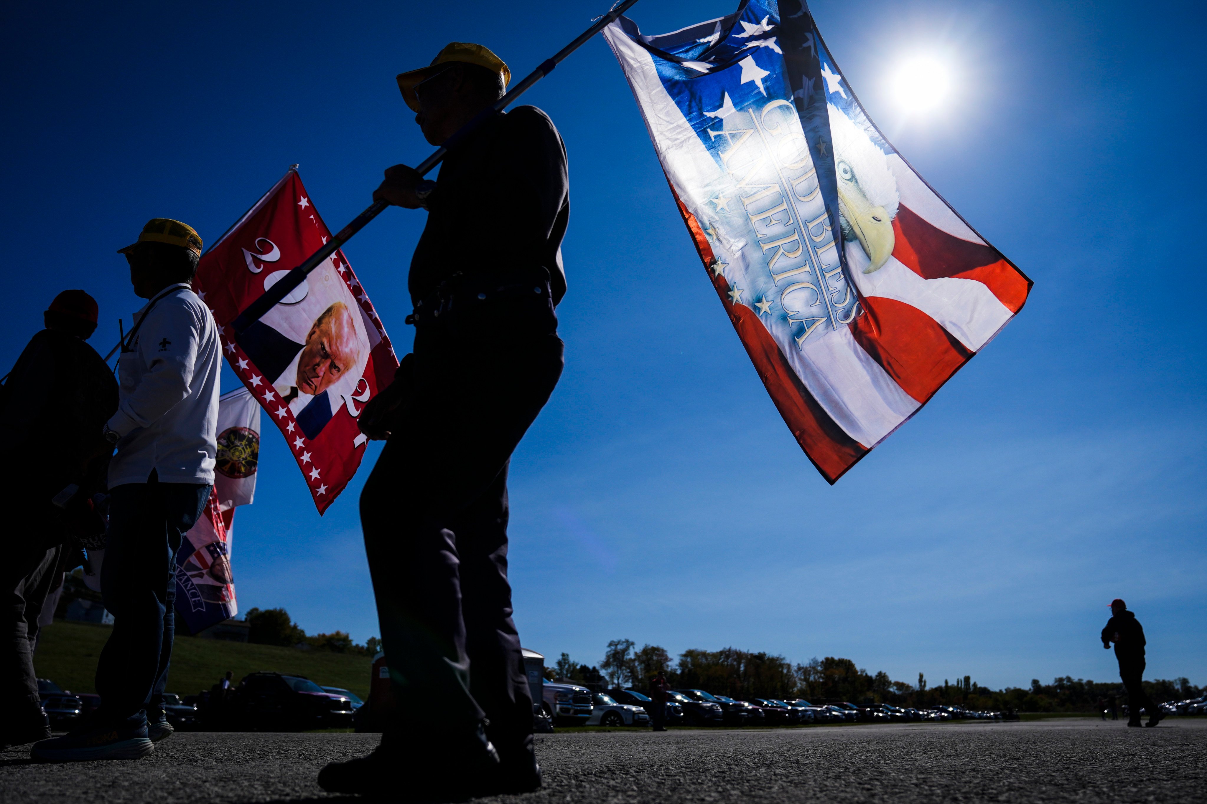 Supporters carry flags ahead of a Donald Trump campaign rally in Latrobe, Pennsylvania, on Saturday. Photo: AP