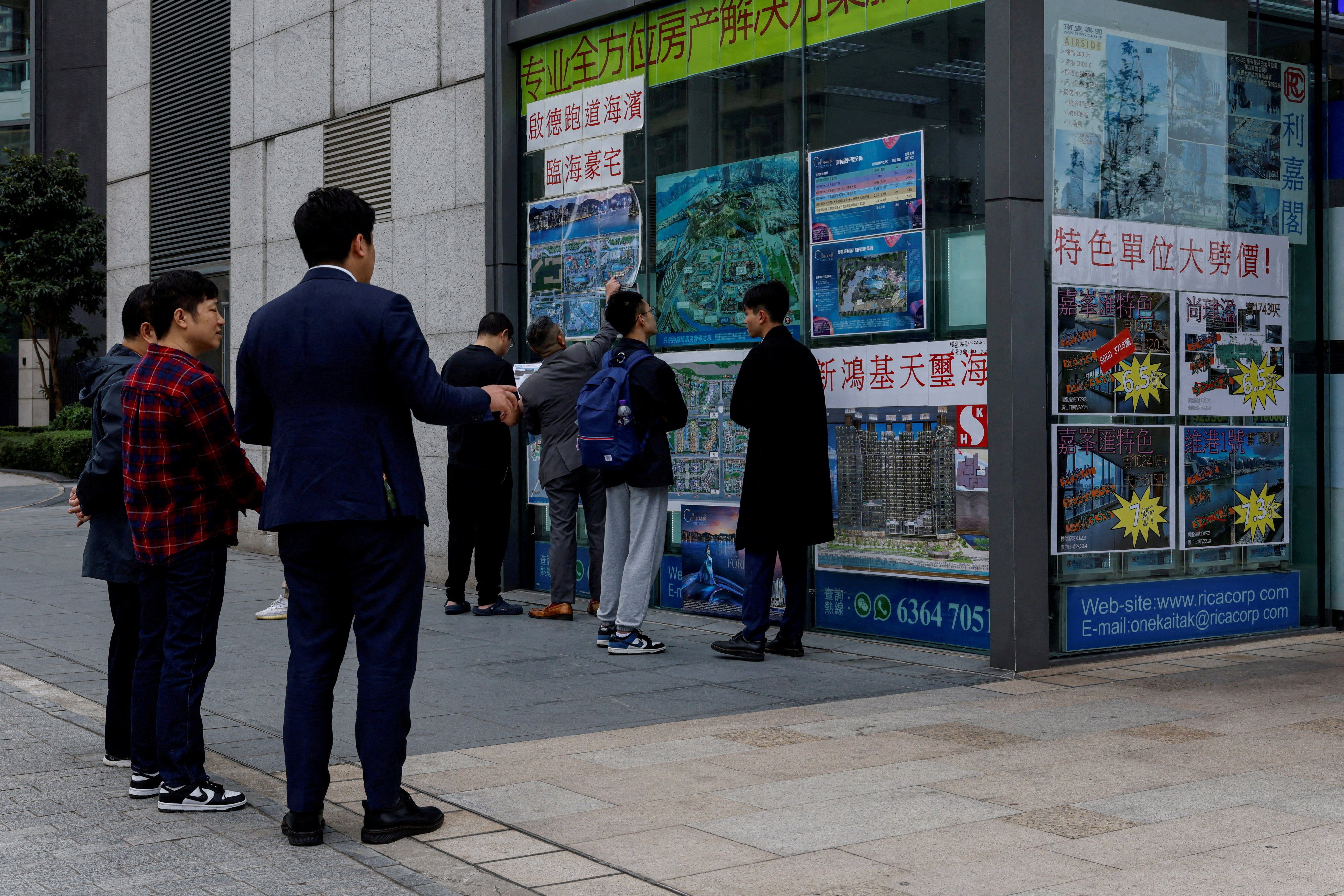 Real estate agents introduce properties to clients, in Hong Kong in February 2024. Photo: Reuters