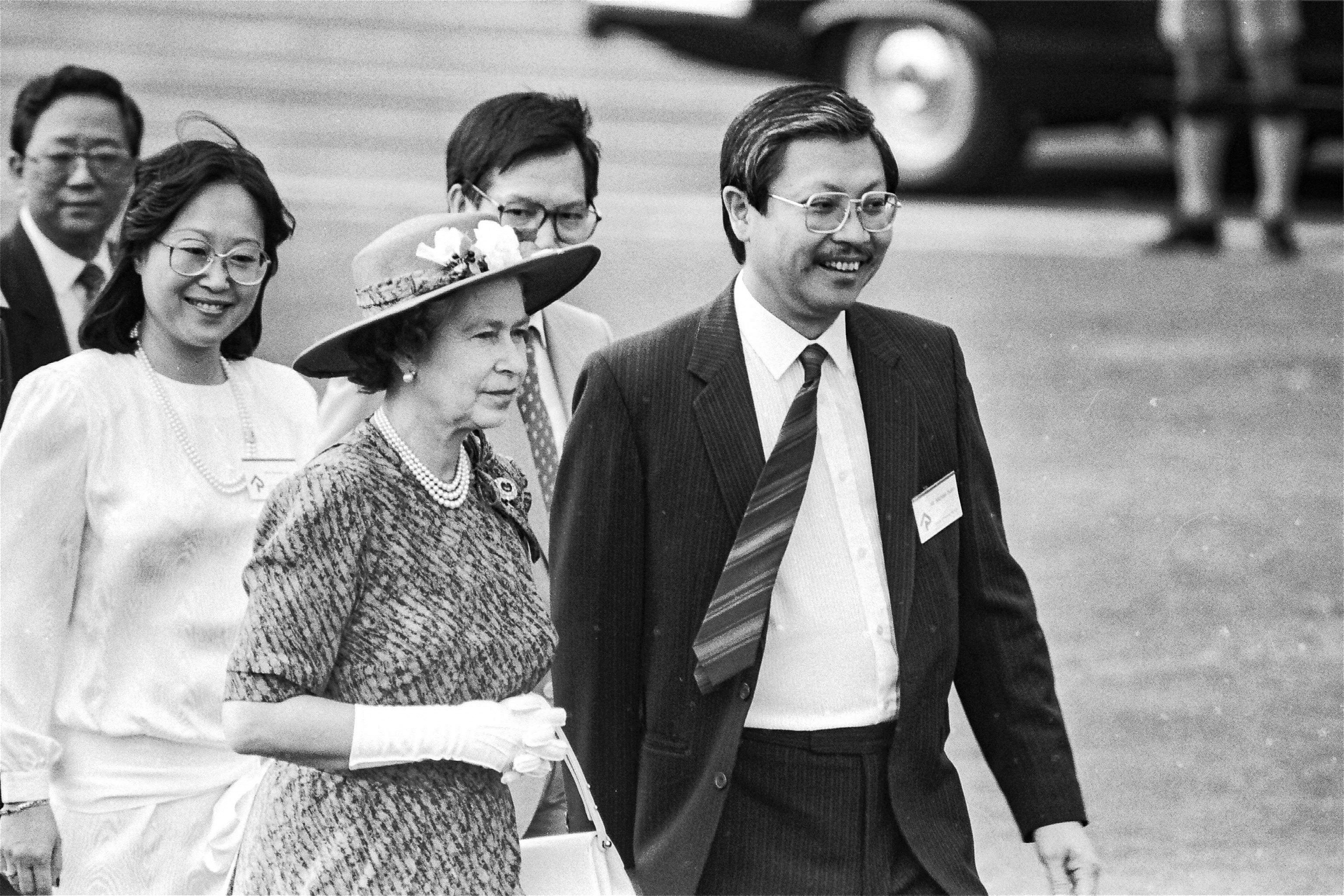 Queen Elizabeth II (left) and Michael Suen (right) during a visit to Sha Tin Recreation Ground. Photo: SCMP