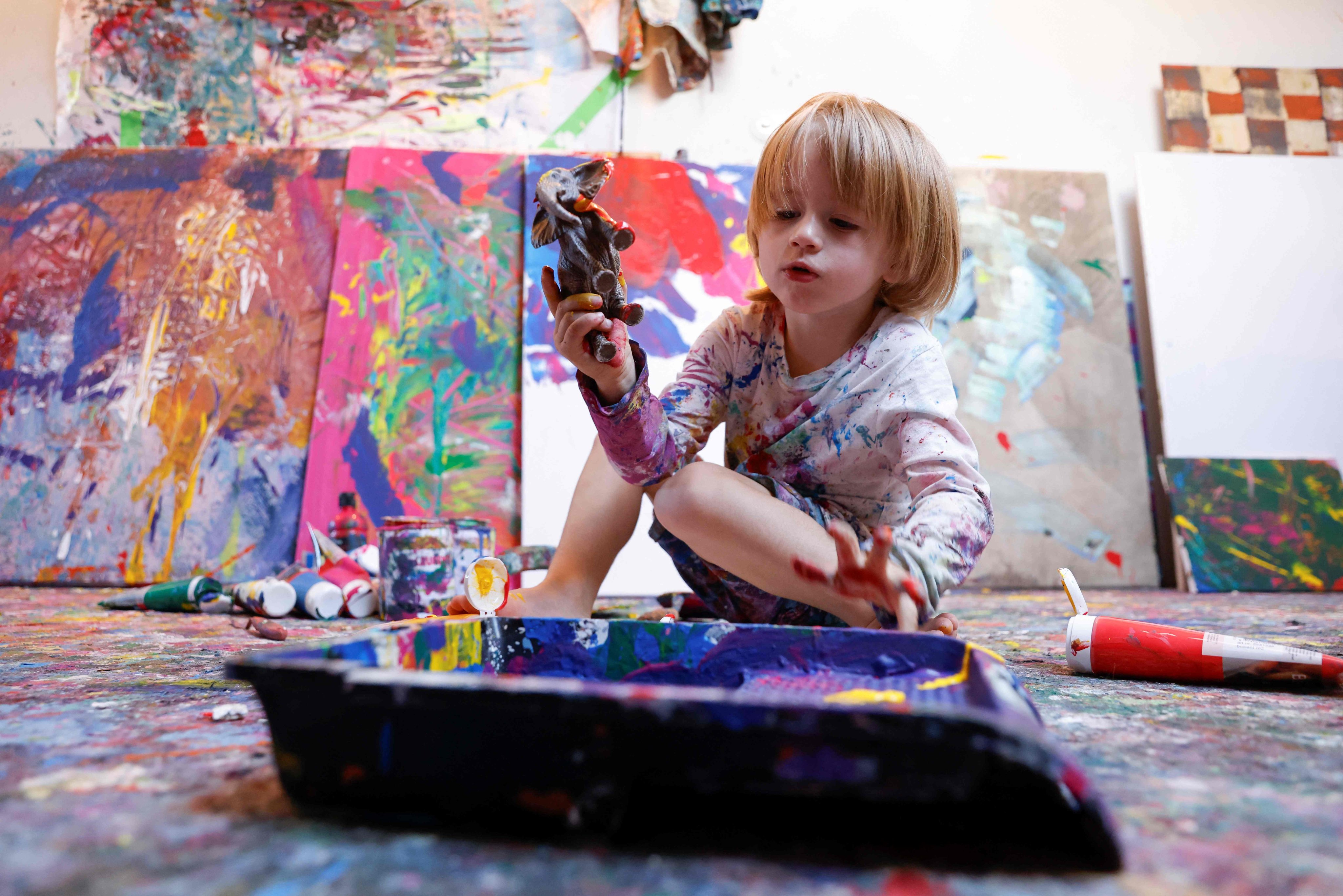 Laurent Schwarz, three years old, paints in his studio. Photo: AFP