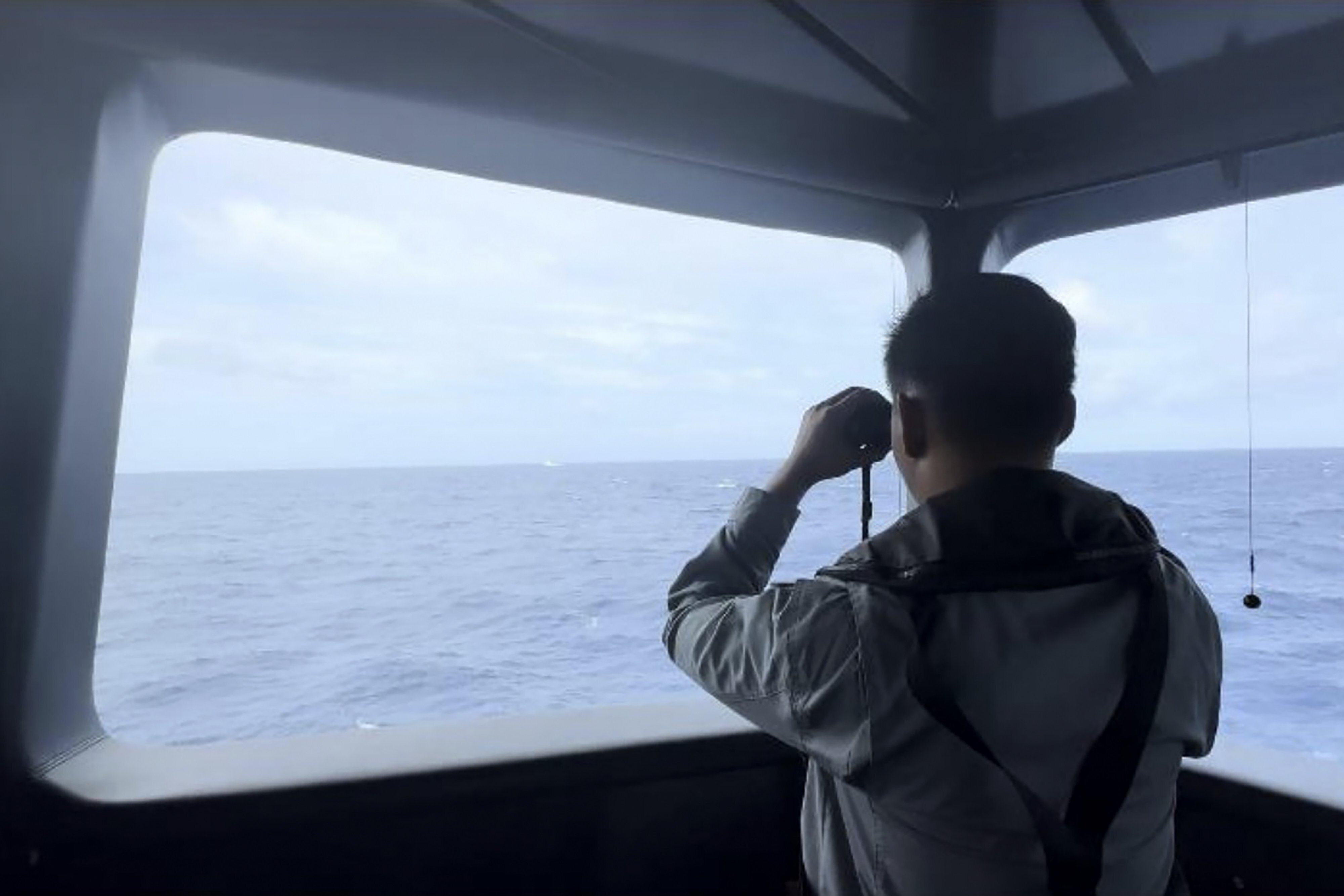 A Maritime Security Agency officer monitors the movement of a Chinese coastguard vessel in the waters of North Natuna Sea in Indonesia. Photo: BAKAMLA via AP