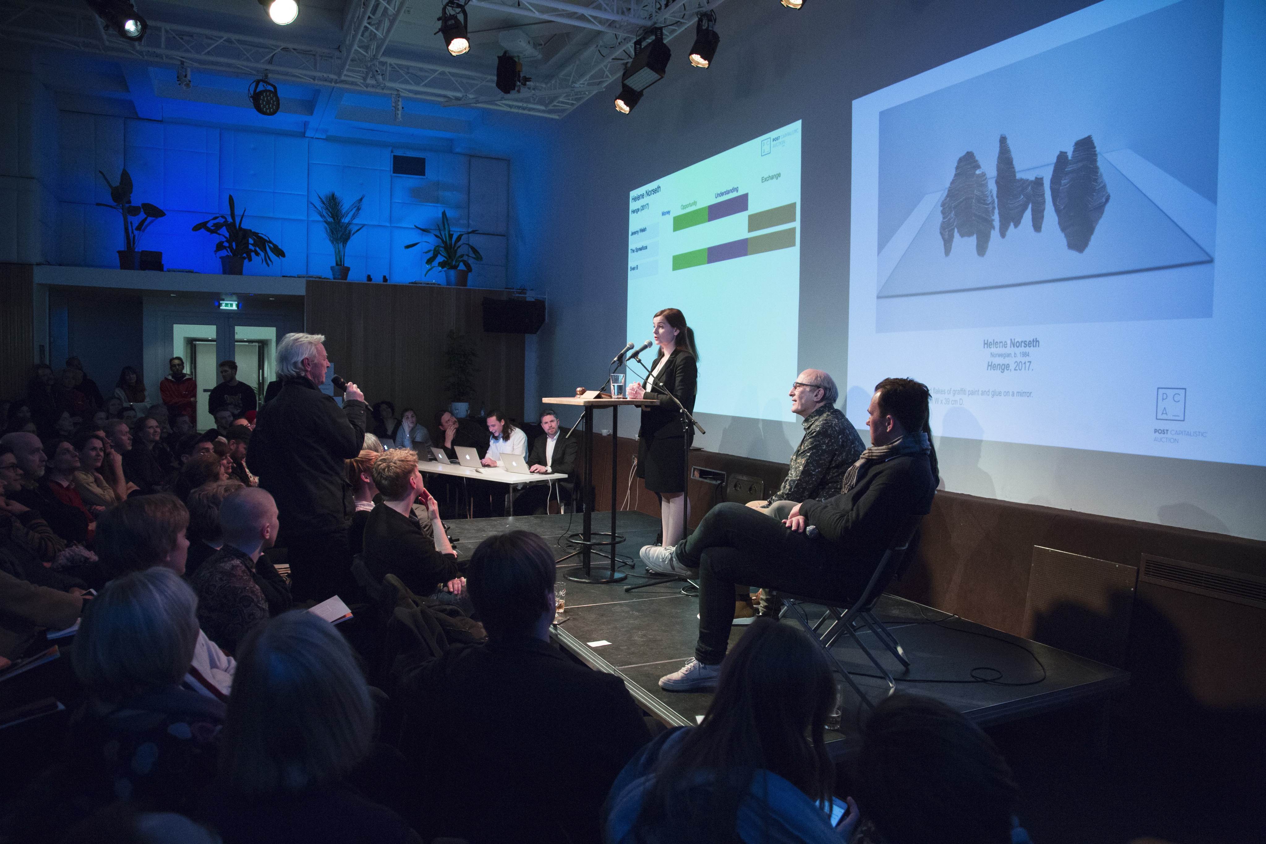 The audience’s real-time online bids for an artwork are shown on a screen during the inaugural Post Capitalistic Auction show in the Norwegian city of Bergen.