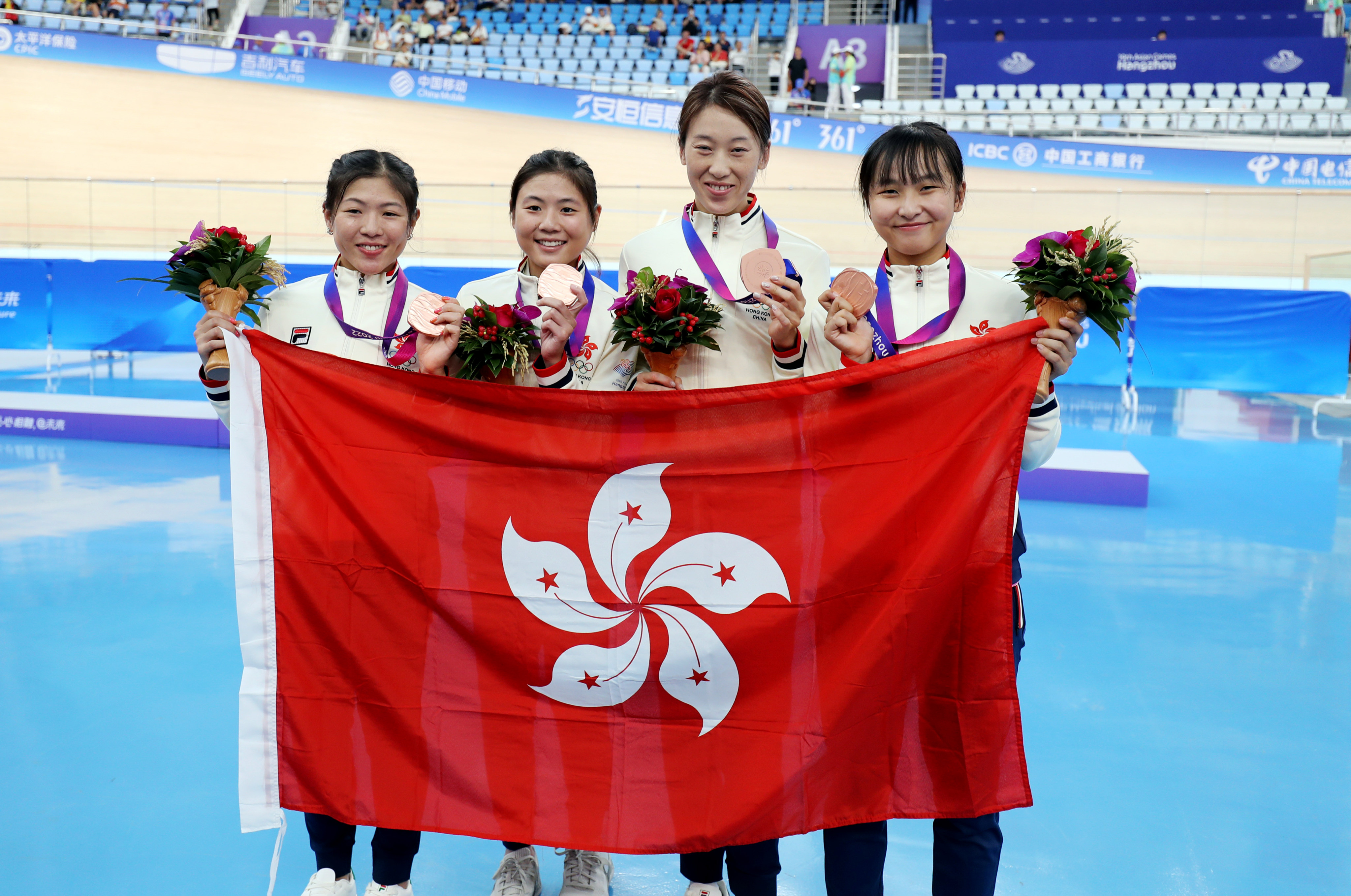 Chloe Leung (second left) and Ceci Lee (far right) after winning the team pursuit bronze at the 2022 Asian Games. Photo: SF&OC