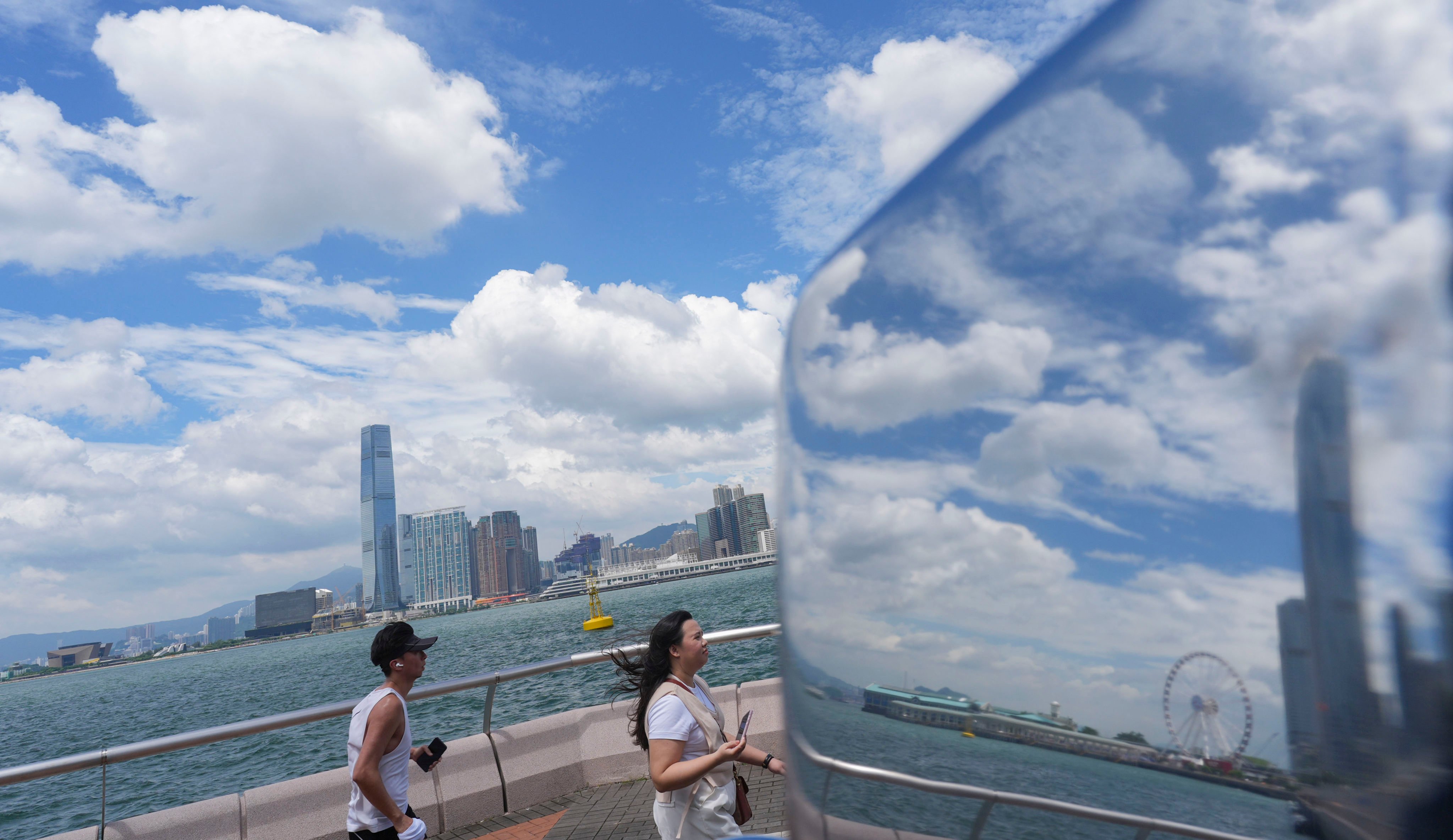 People walk along the waterfront on Hong Kong Island on September 5. Photo: Eugene Lee