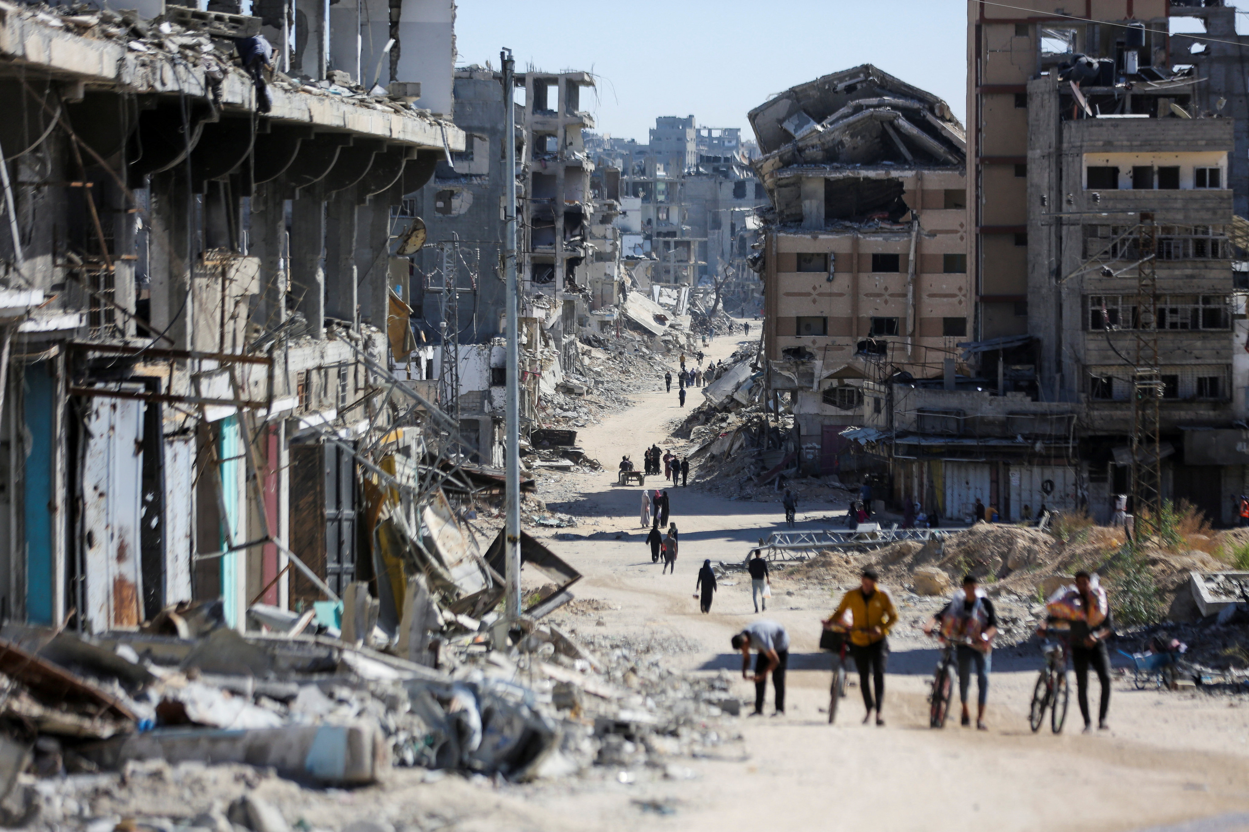 Palestinians make their way in a devastated neighbourhood in Gaza City. Photo: Reuters