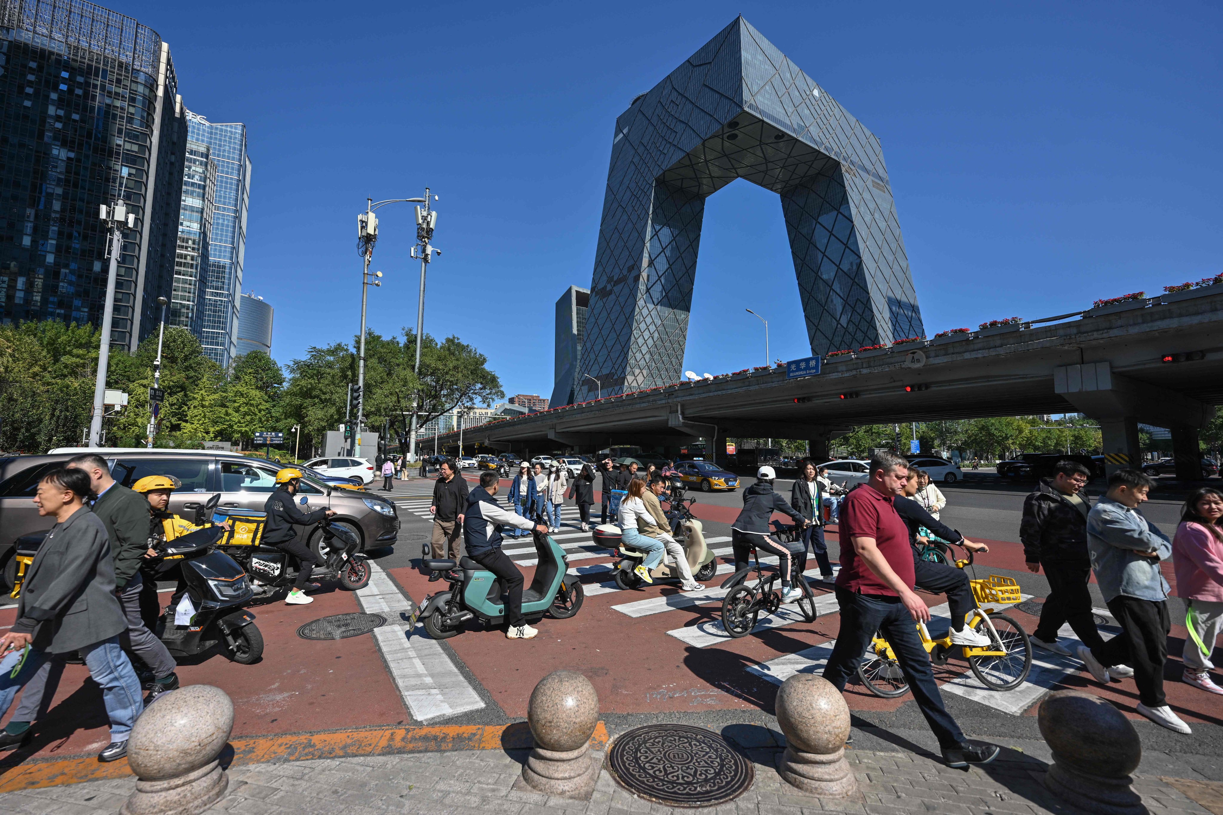 People crossed a road in Beijing’s business district. Photo: AFP 