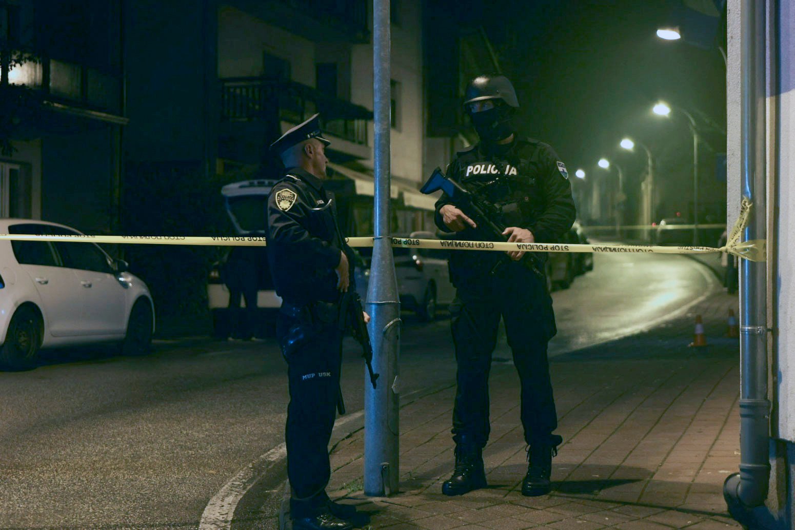 Bosnian police officers guard the local police station after a teenager broke and killed one officer with a knife and wounded another, in the town of Bosanska Krupa. Photo: AP