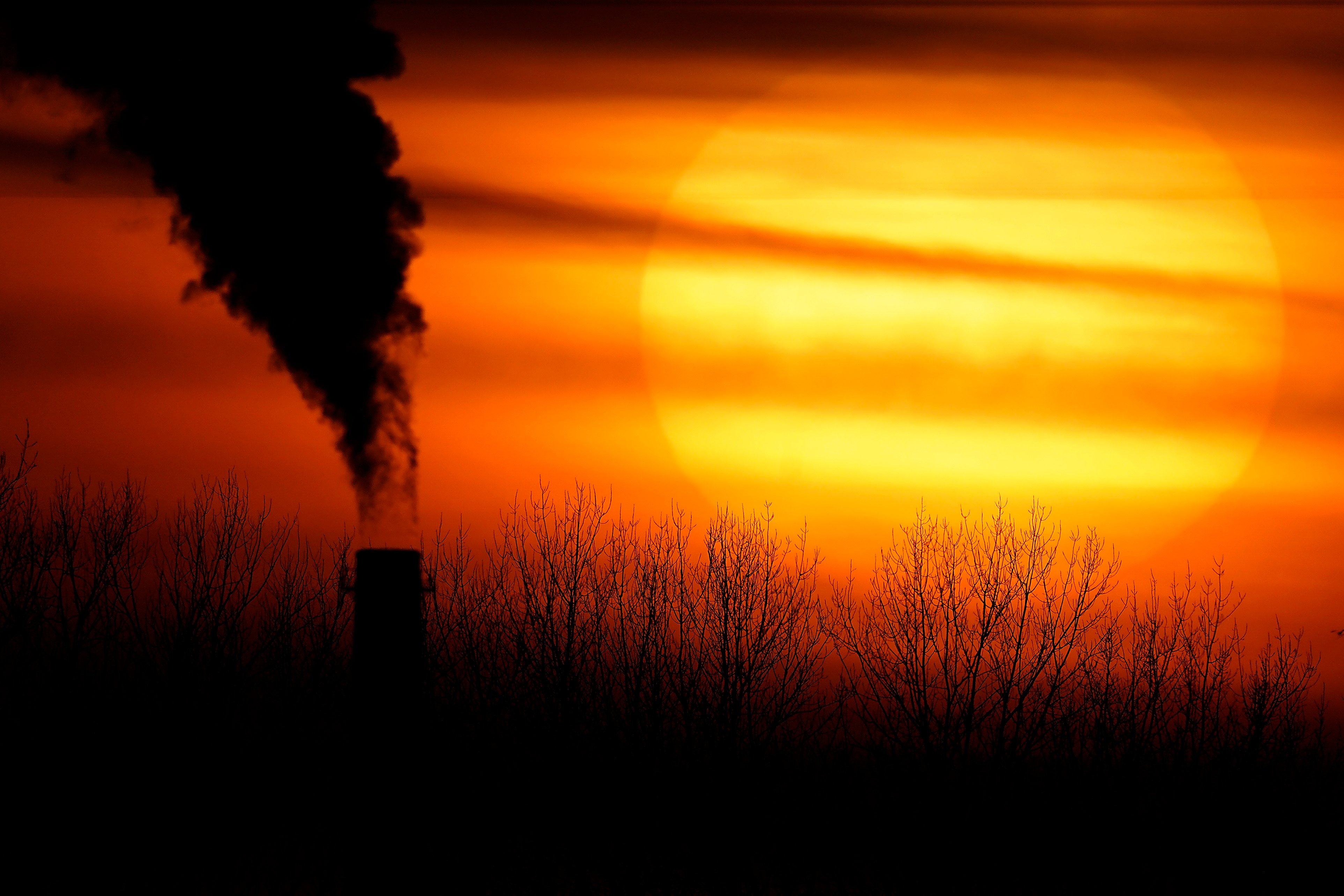 Emissions from a coal-fired power plant are silhouetted against the setting sun in Kansas City, Missouri. File photo: AP