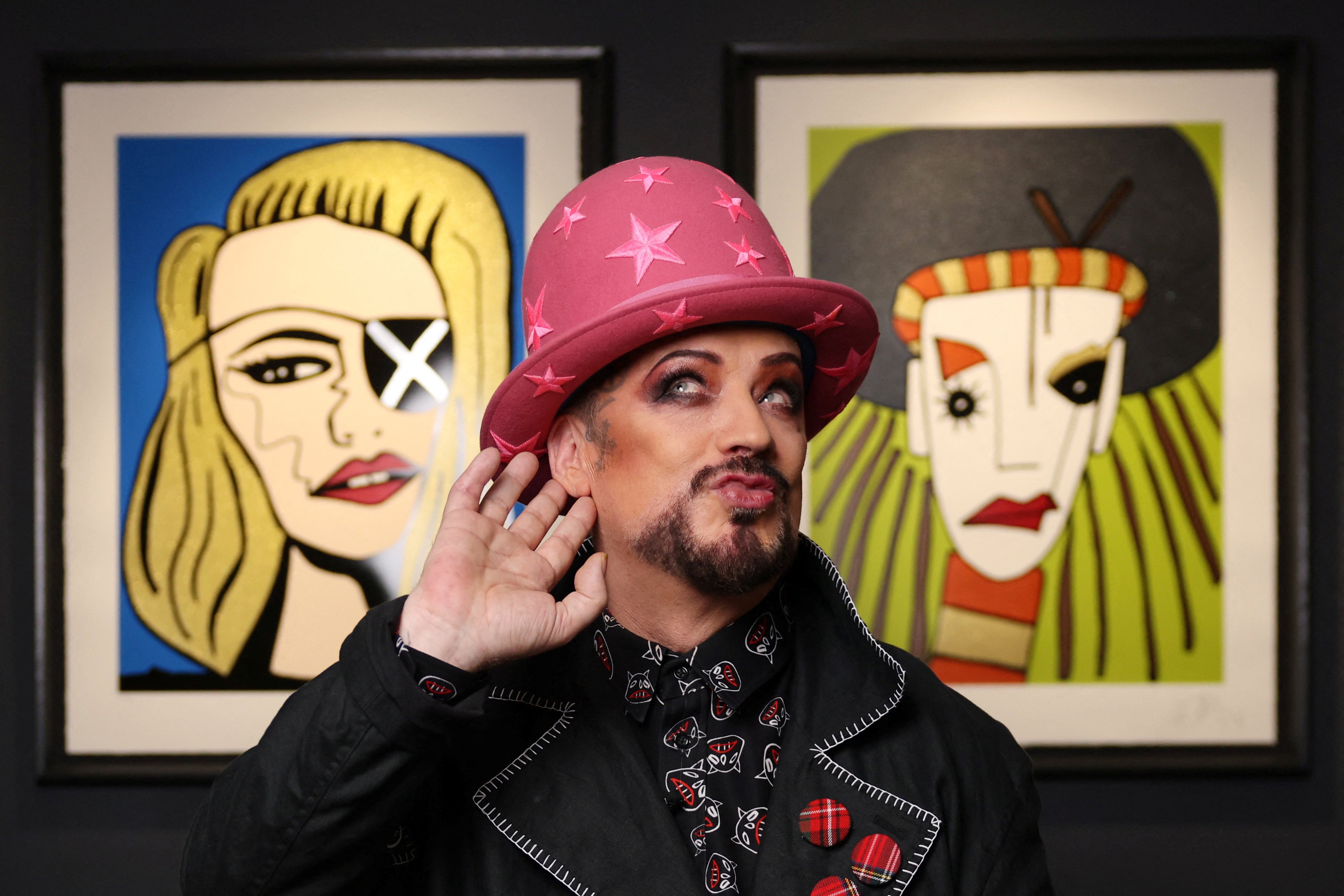 Boy George poses in front of his portrait of Madonna (left) and a self-portrait of himself during his Culture Club days from “Fame”, a limited-edition collection with British art retailer Castle Fine Art, on October 23, 2024. Photo: Reuters