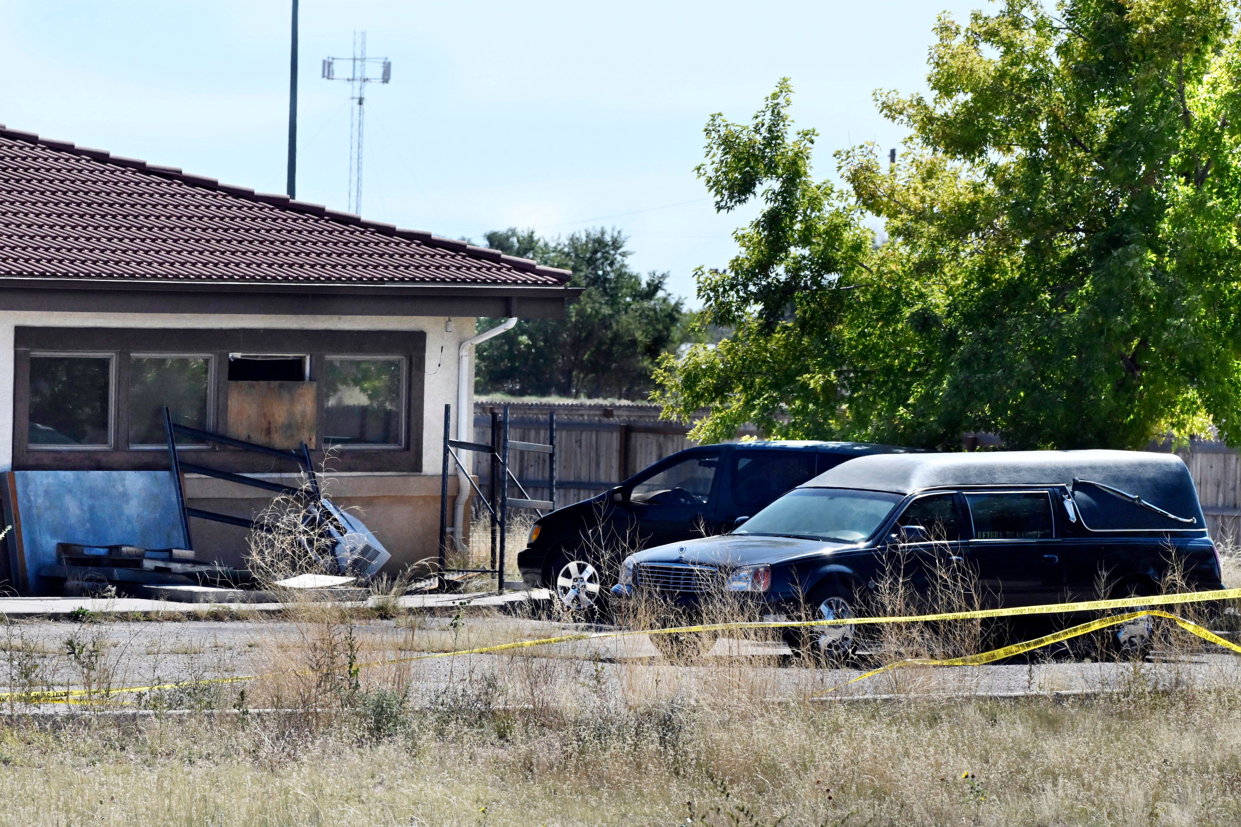 A hearse and debris at the rear of the Return to Nature Funeral Home in Penrose, Colorado in 2023. Photo: The Gazette via AP