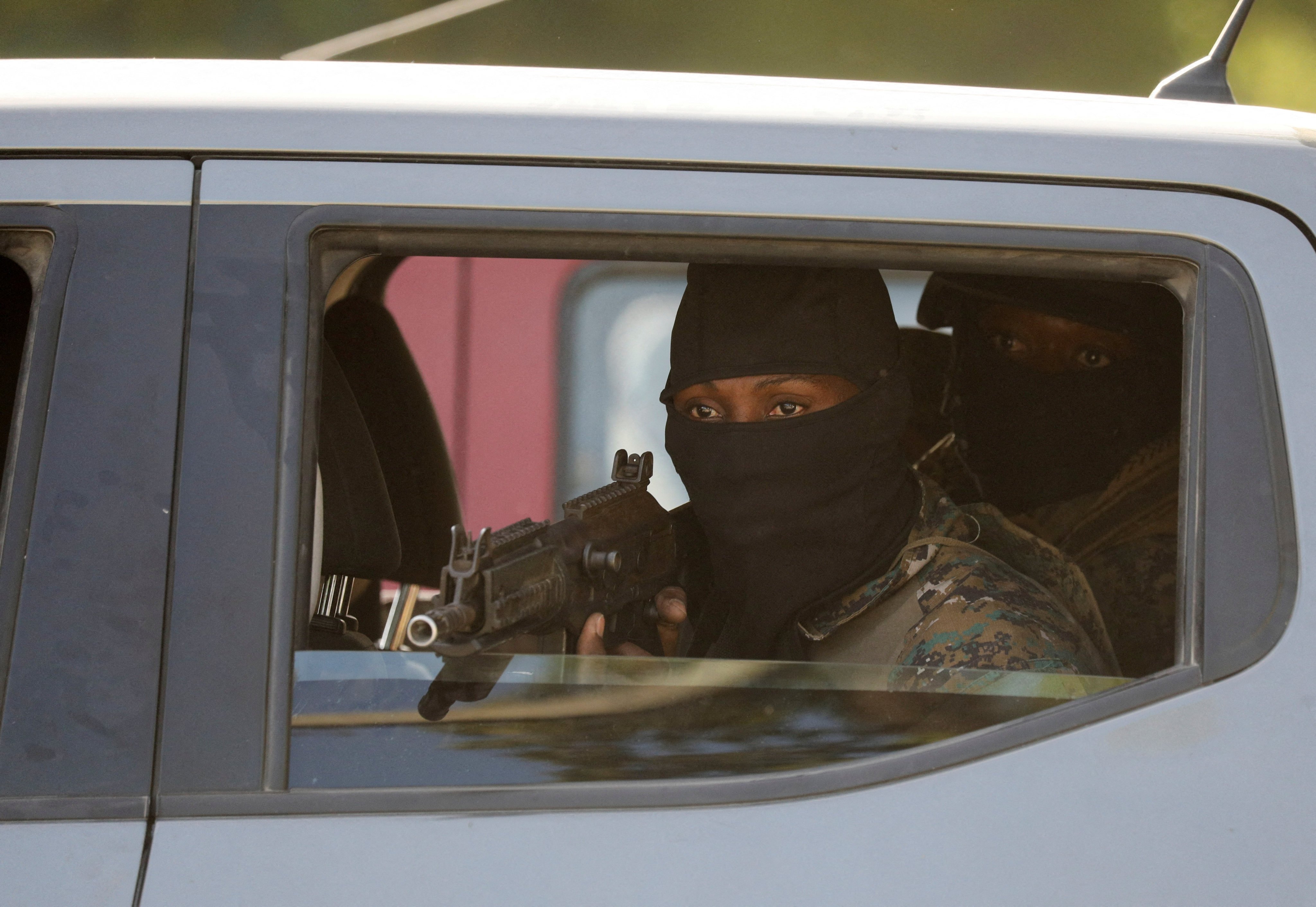 Security personnel escort the car of a member of Haiti’s presidential council in Port-au-Prince, Haiti. Photo: Reuters