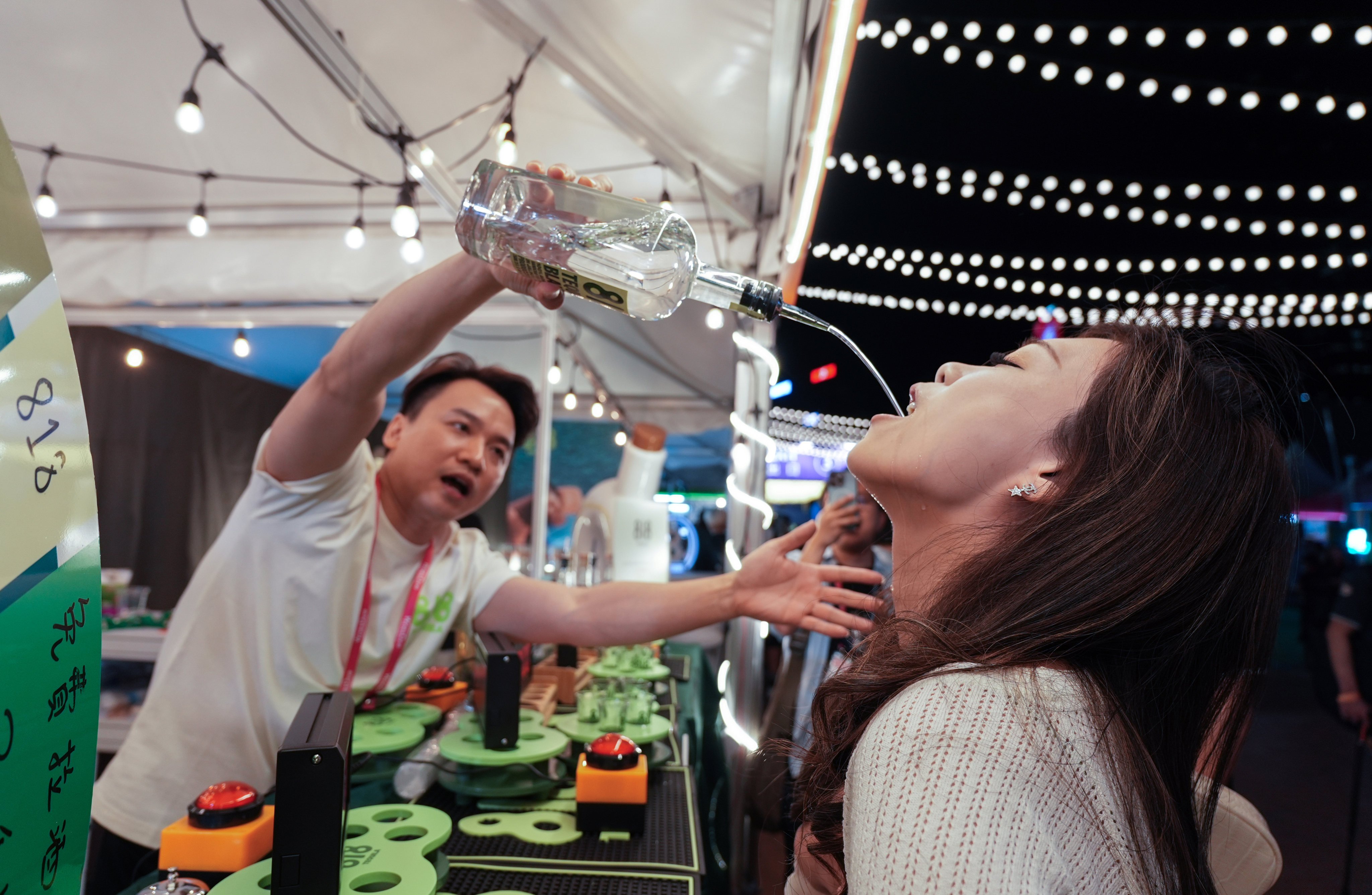 Visitors take part in a drinking competition at the Wine & Dine Festival in Central on October 23. Photo: Eugene Lee