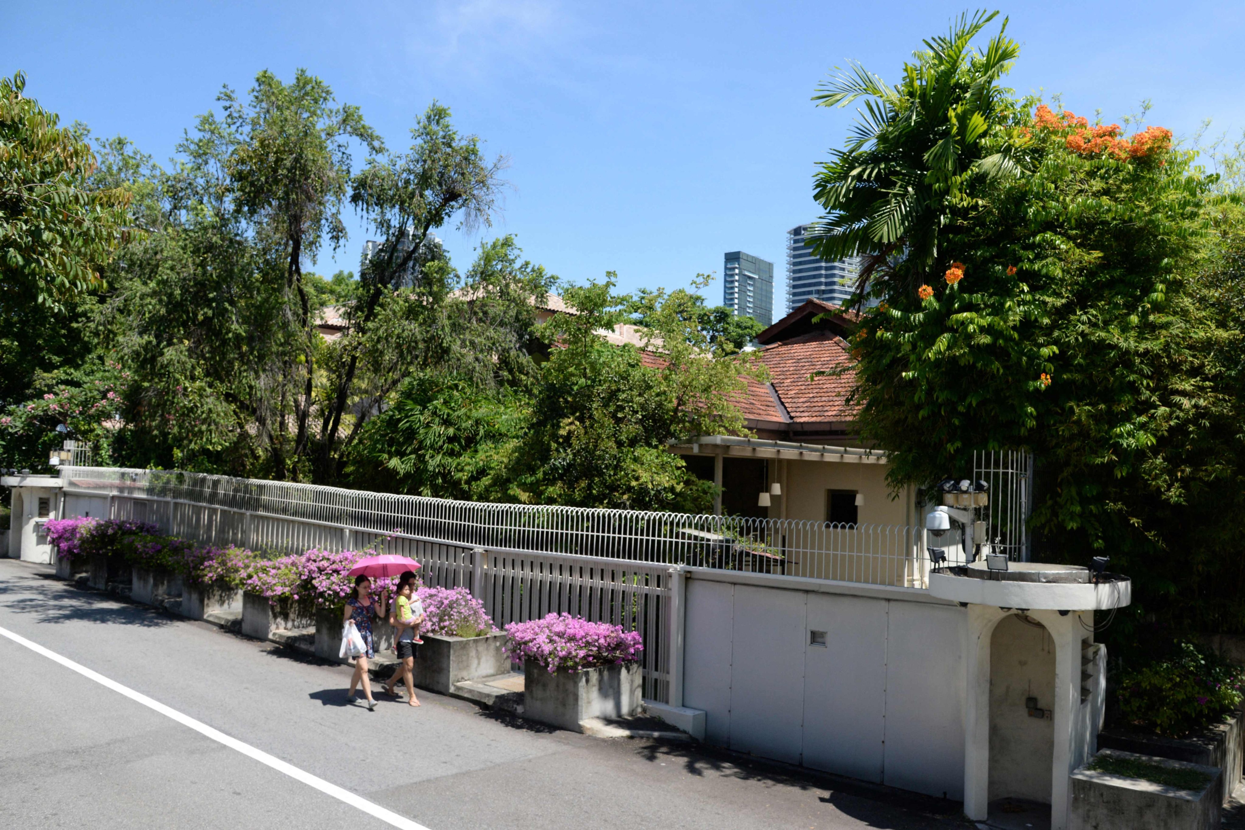 People walk past Lee Kuan Yew’s house at 38 Oxley Road in Singapore. Photo: AFP