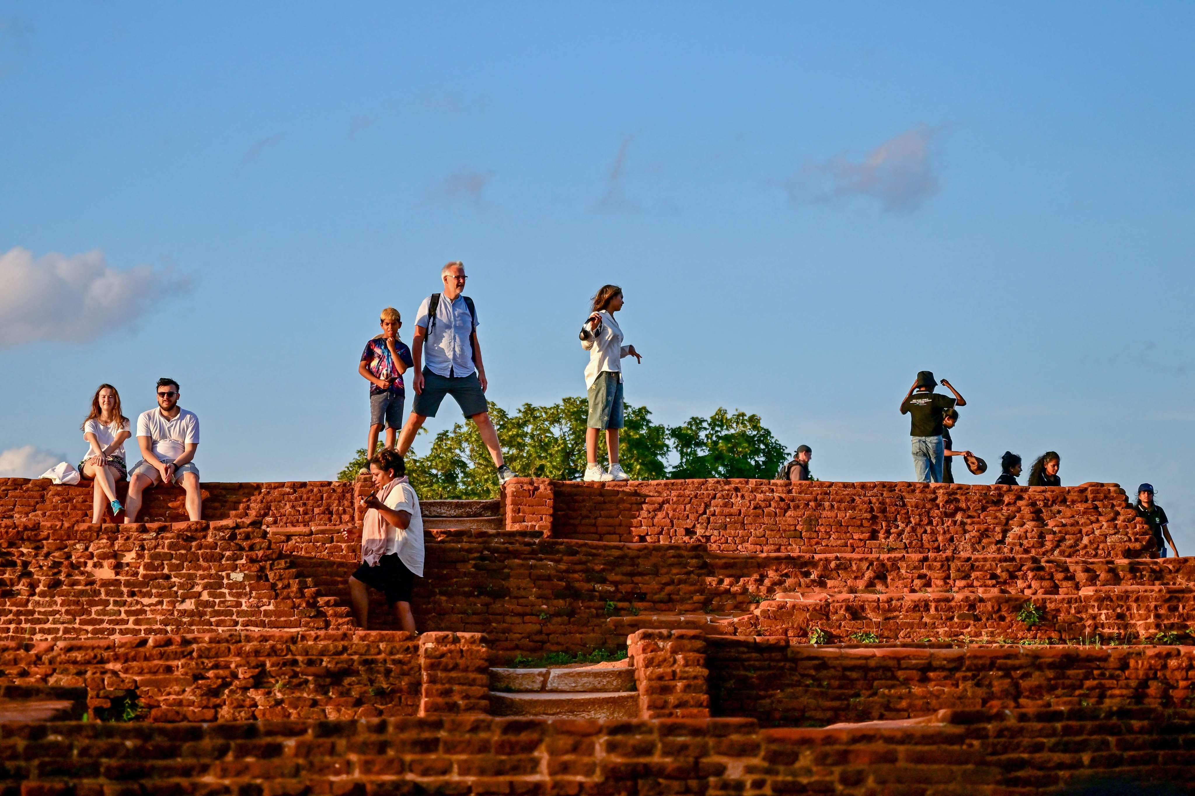 Tourists visit the ancient rock fortress in Sigiriya, in Sri Lanka, on October 16. Photo: AFP