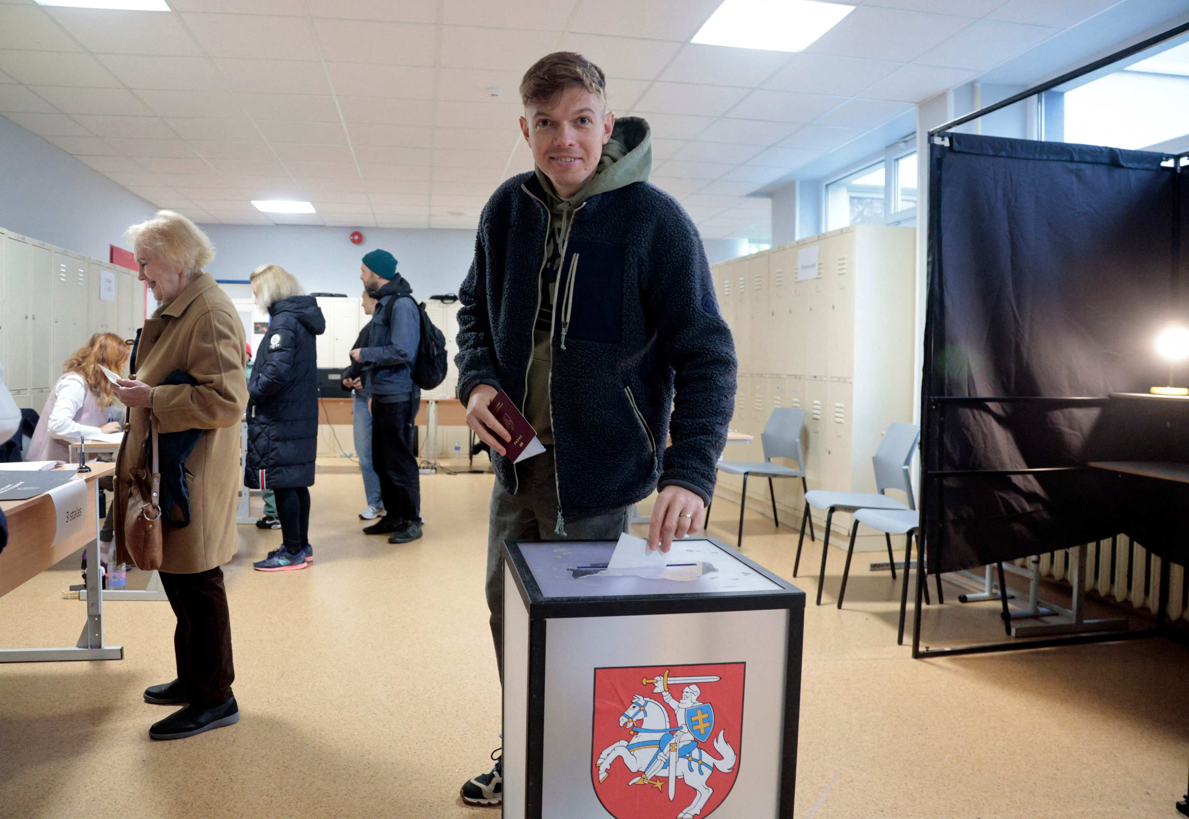 A man casts his ballot during the second round of parliamentary elections at a polling station in Vilnius, Lithuania, on Sunday. Photo: AFP