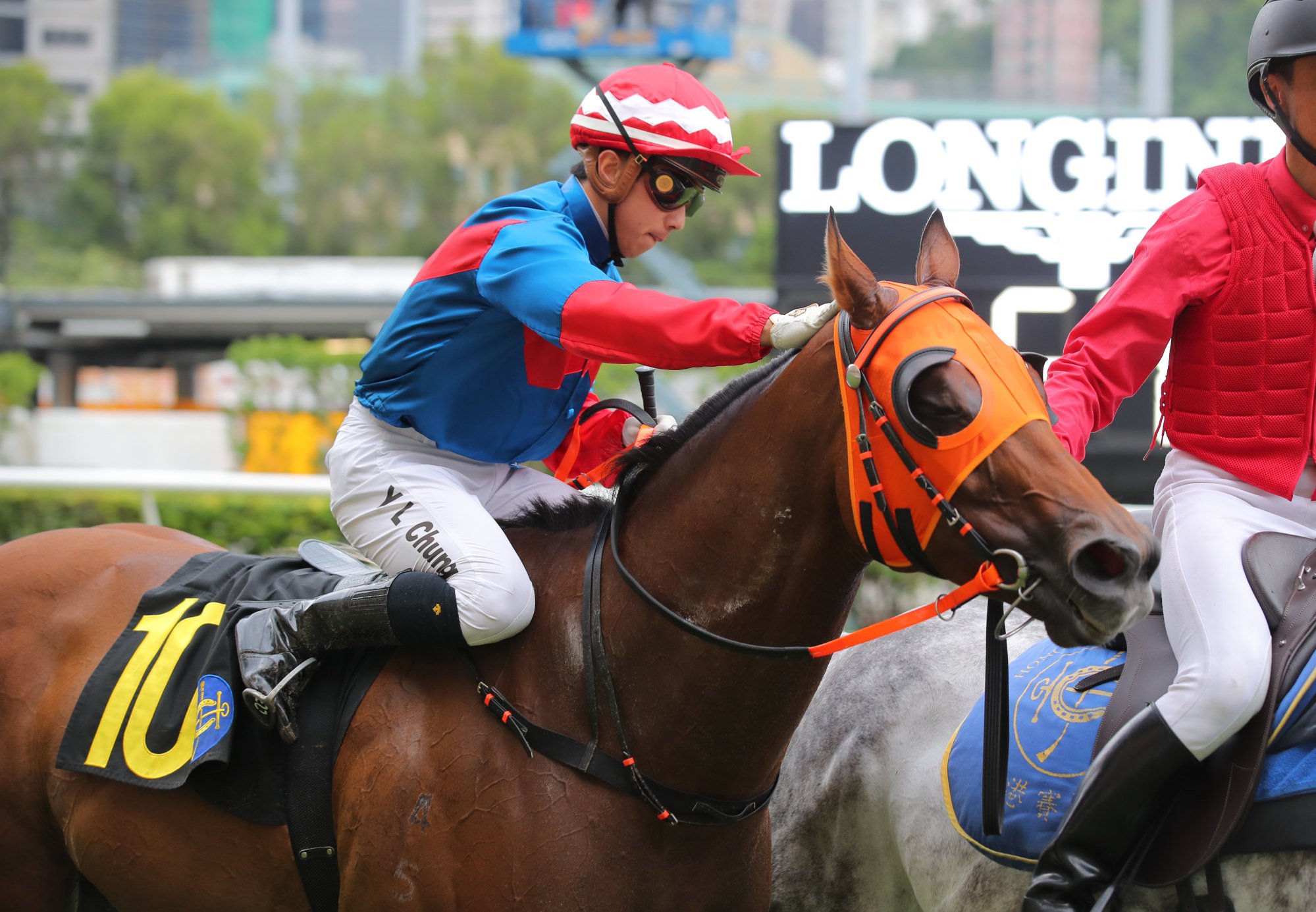 Angus Chung gives Happy Tango a pat after guiding him to victory at the Valley.