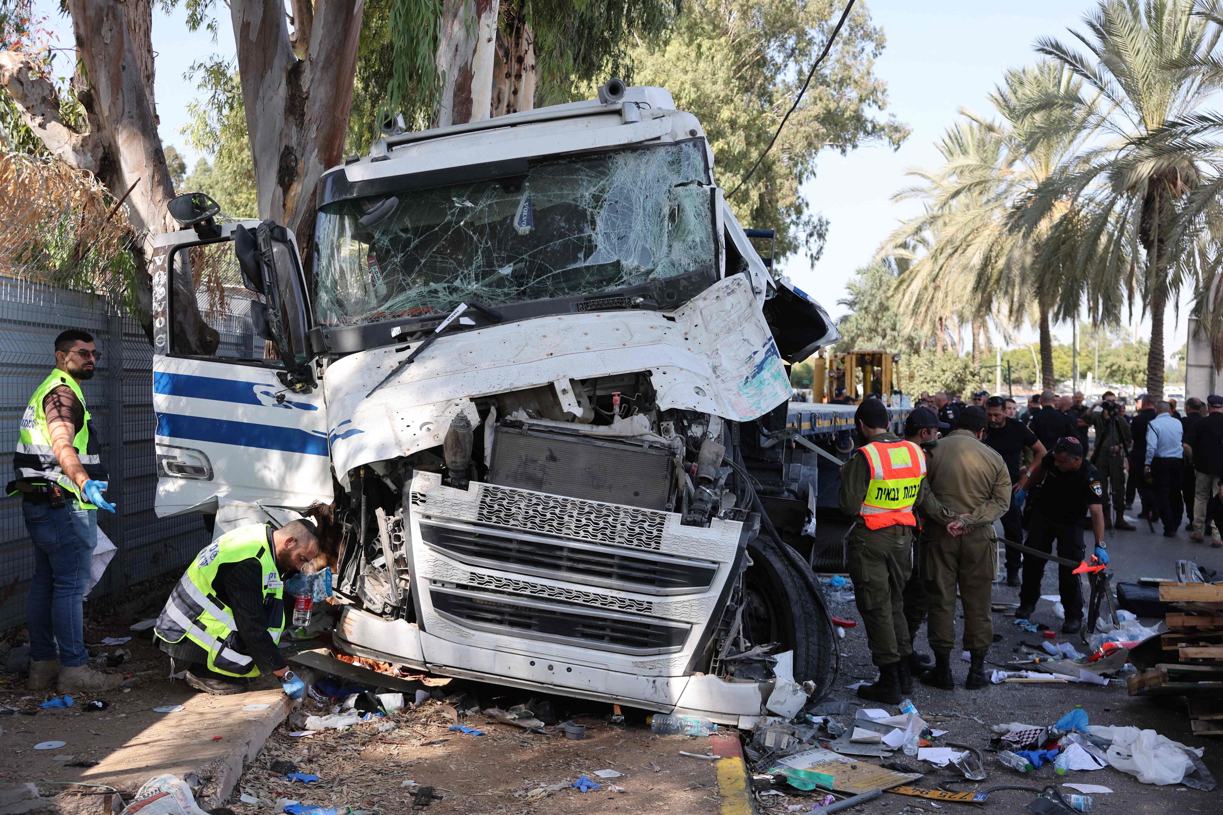 Israeli emergency responders secure the site after a driver rammed his truck into a crowd of people at a bus stop in Ramat Hasharon, north of Tel Aviv, on Sunday. Photo: AFP