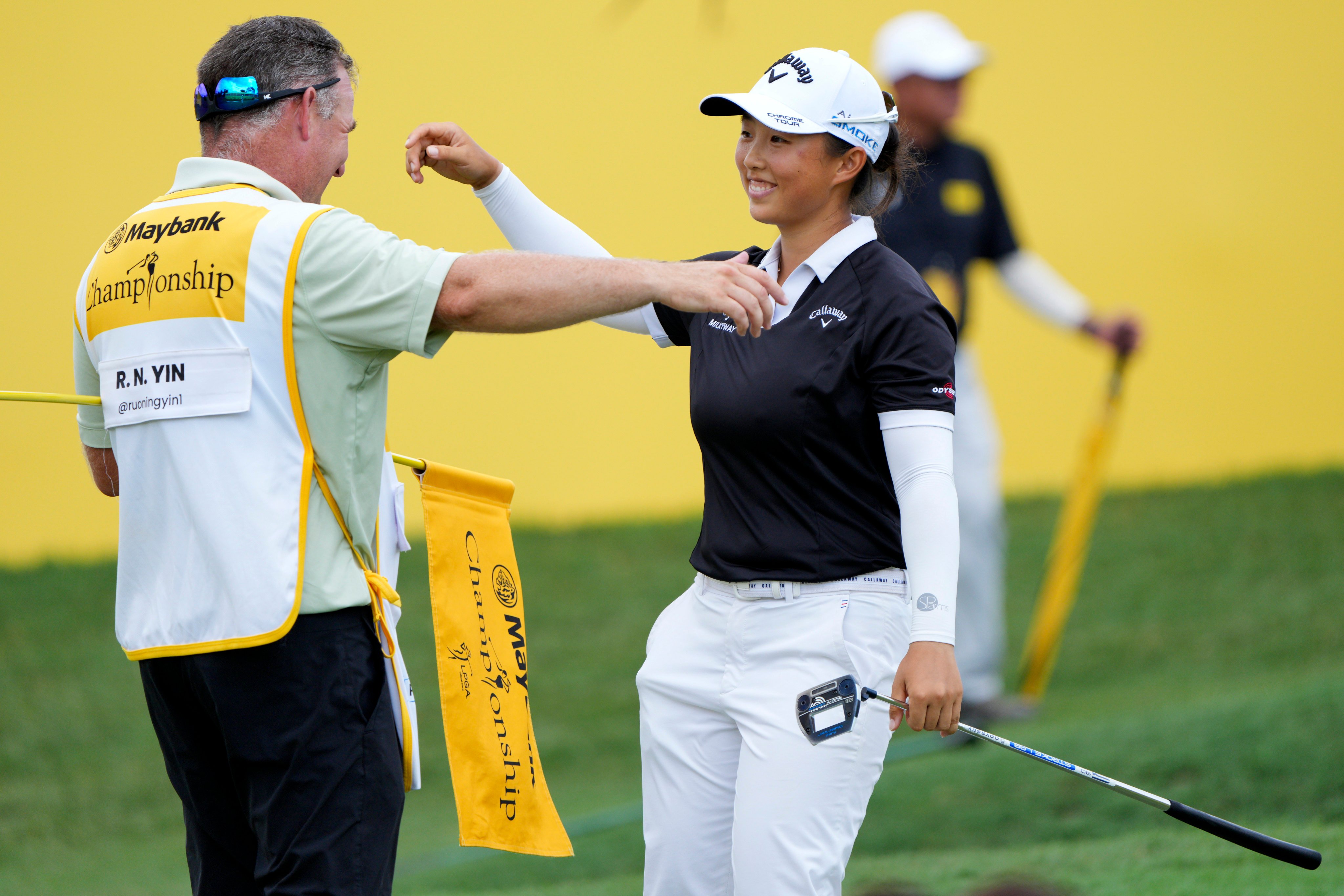 Yin Ruoning of China celebrates with her caddie on the 18th hole after winning the LPGA Tour’s Maybank Championship at Kuala Lumpur Golf and Country club on Sunday. Photo: AP