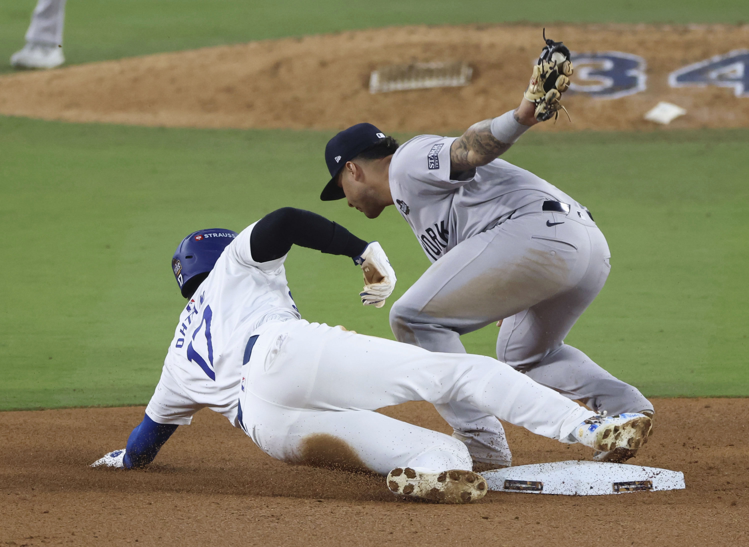 LA Dodgers designated hitter Shohei Ohtani (bottom) is caught stealing second base in the seventh inning of Game 2 of the World Series against the New York Yankees. Photo: Kyodo