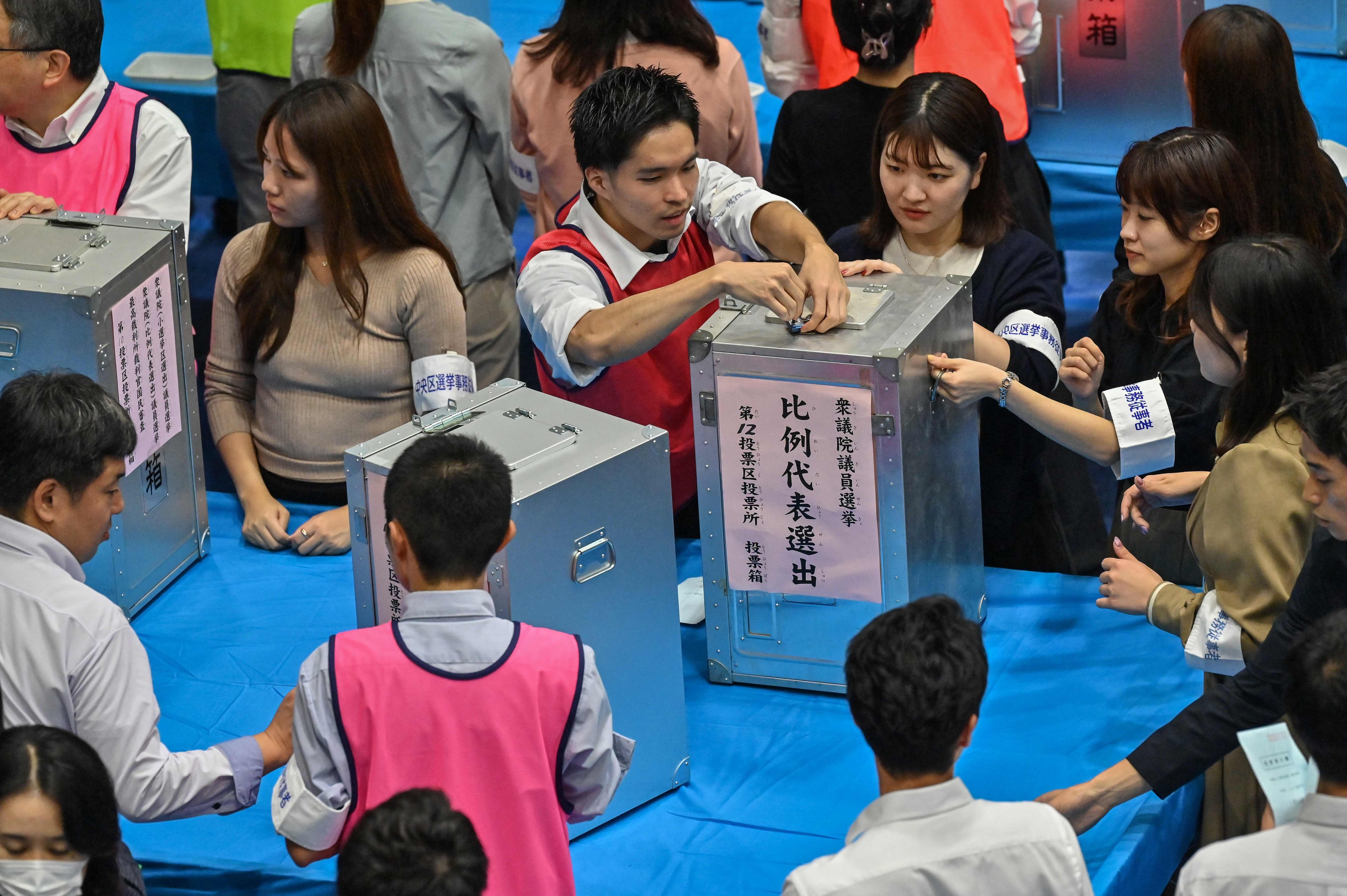 Officials of the election administration committee open ballot boxes to count the votes for Japan’s general election in Tokyo on Sunday. Photo: AFP