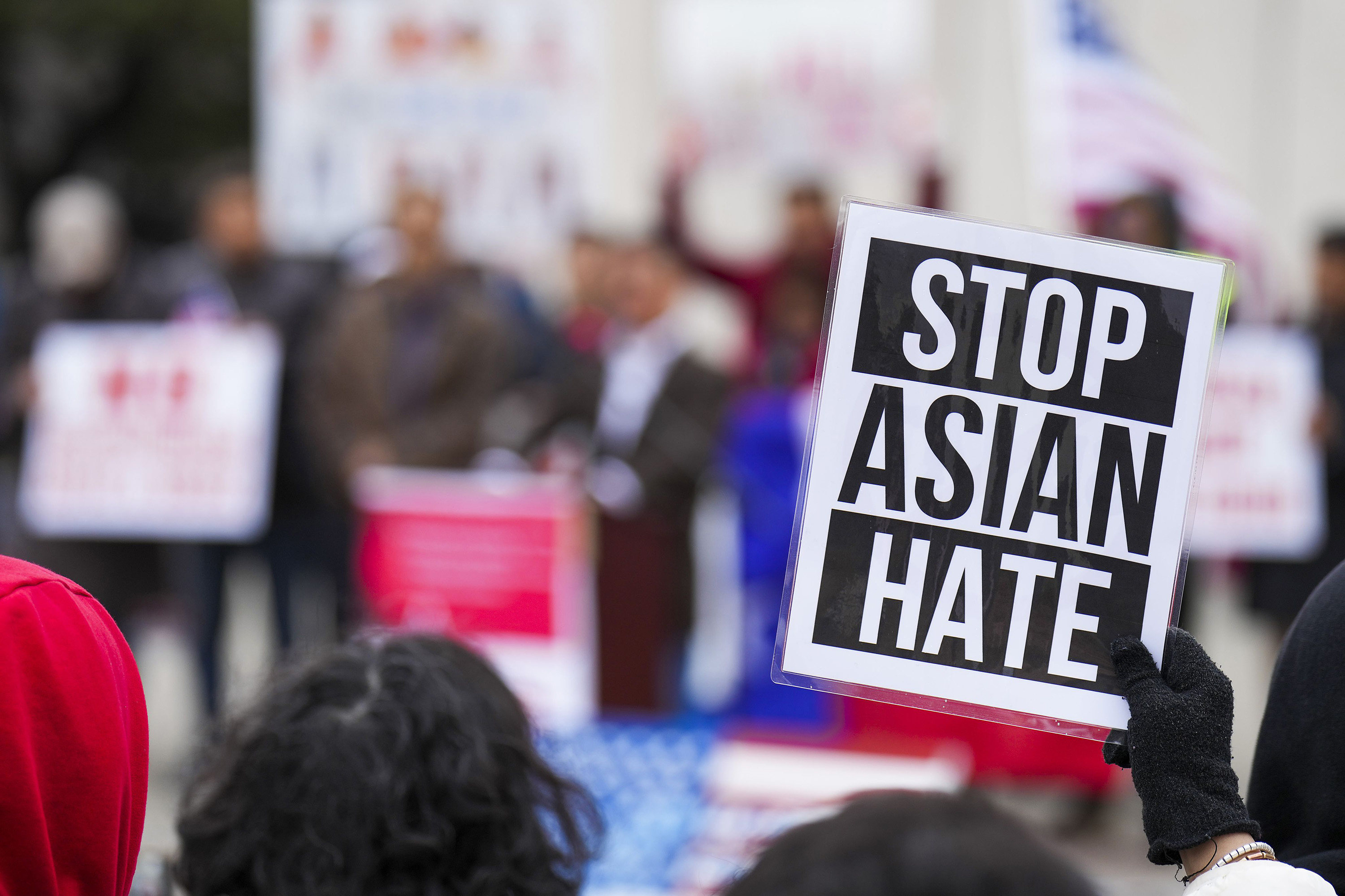 A woman holds a sign during a rally in opposition to a 2023 Texas Senate bill that would outlaw real estate property ownership by people from China, Iran, North Korea and Russia. Photo: TNS